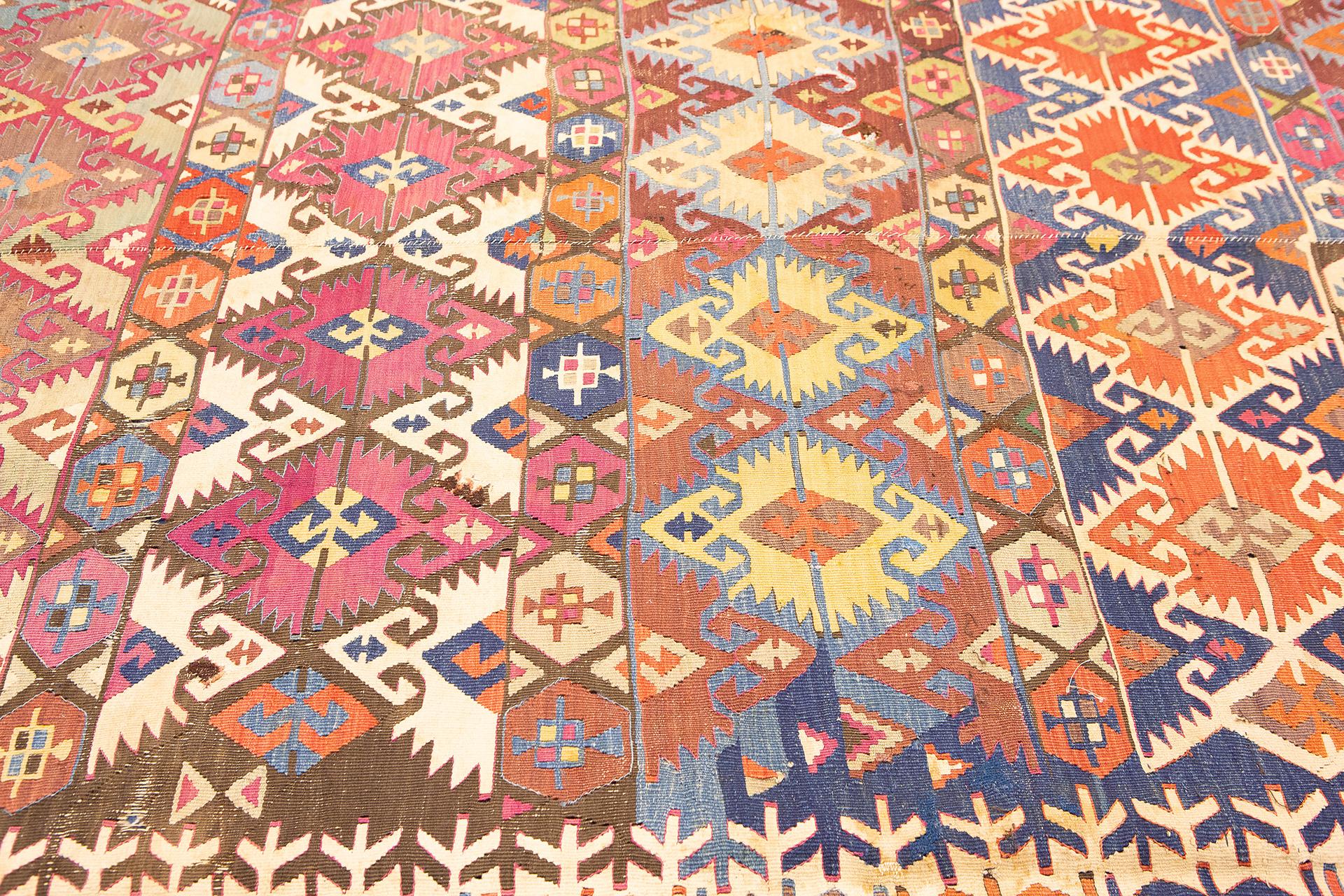 This magnificent Turkish Anatolian Kilim rug, measuring 450 x 165 cm, is a breathtaking example of traditional craftsmanship and vibrant design. Every detail of this handwoven masterpiece invites you to explore its rich tapestry of colors and