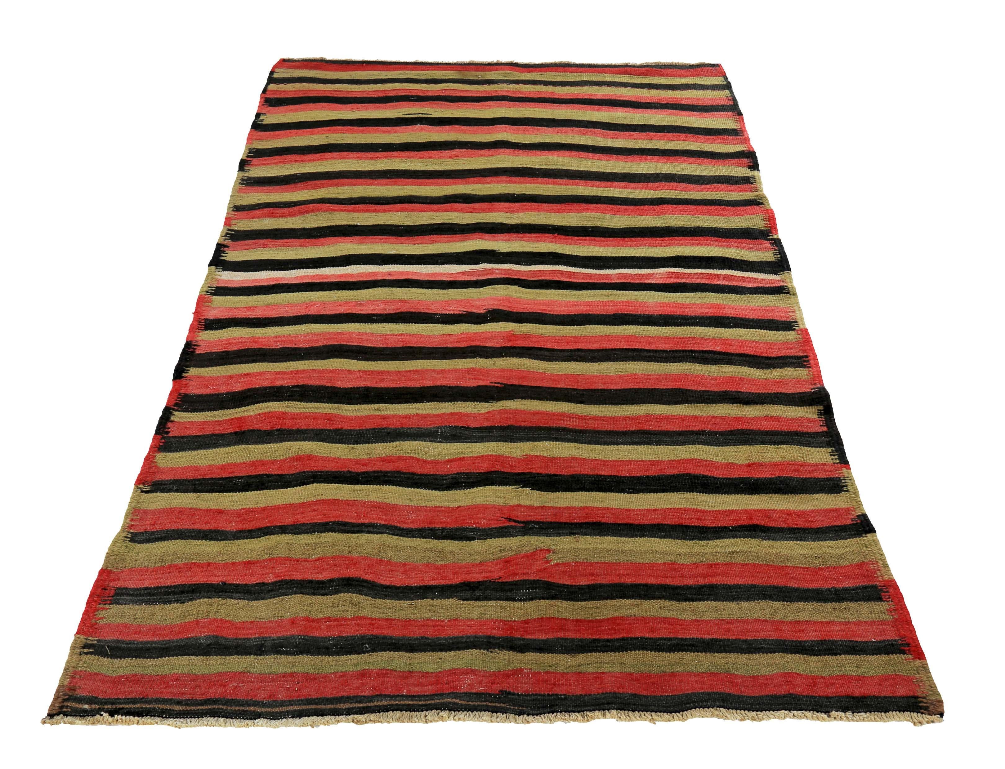 Turkish rug handwoven from the finest sheep’s wool and colored with all-natural vegetable dyes that are safe for humans and pets. It’s a traditional Kilim flat-weave design featuring black and red tribal stripes over a lovely gold field. It’s a