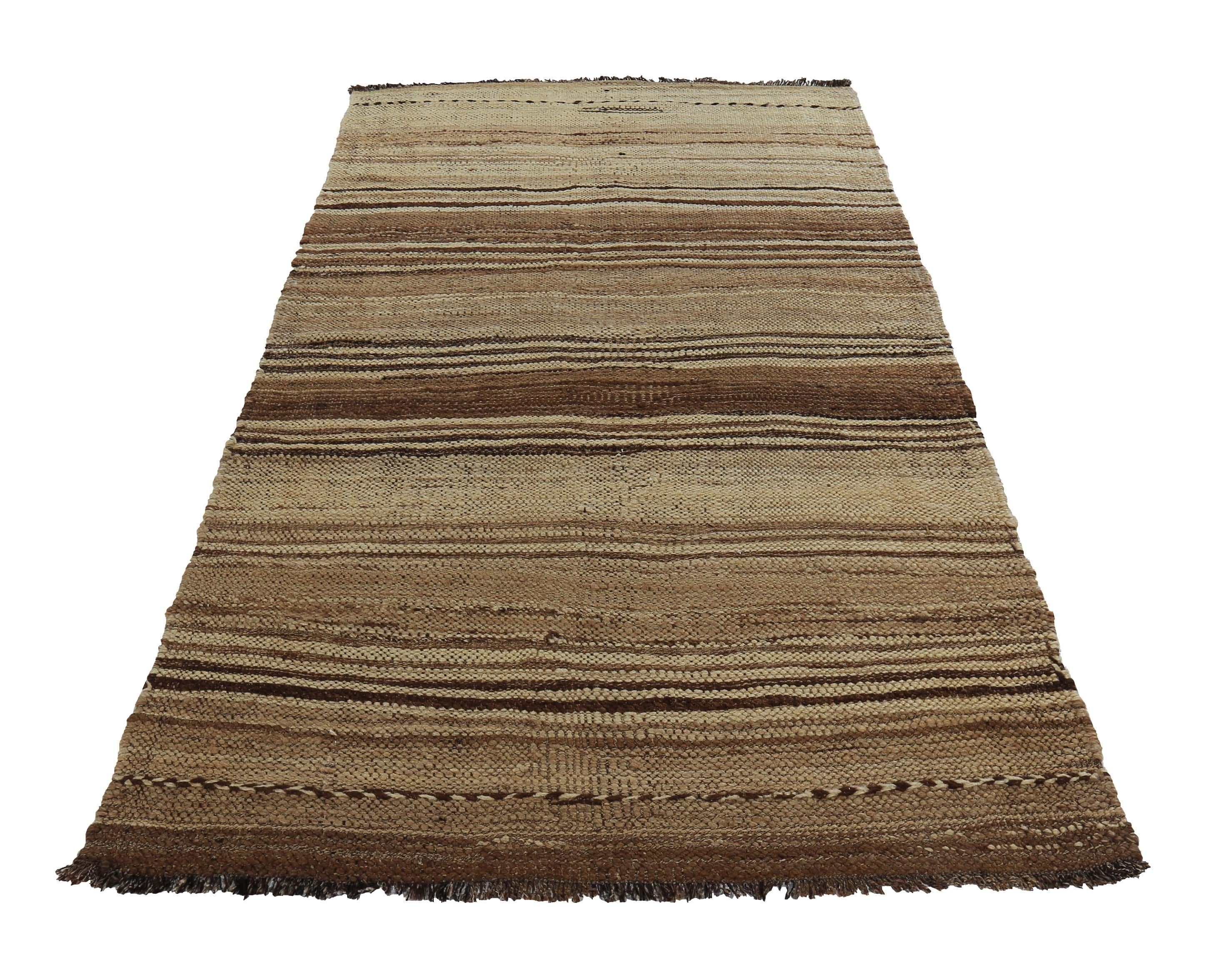 Turkish rug handwoven from the finest sheep’s wool and colored with all-natural vegetable dyes that are safe for humans and pets. It’s a traditional Kilim flat-weave design featuring brown tribal stripes over a lovely ivory field. It’s a stunning
