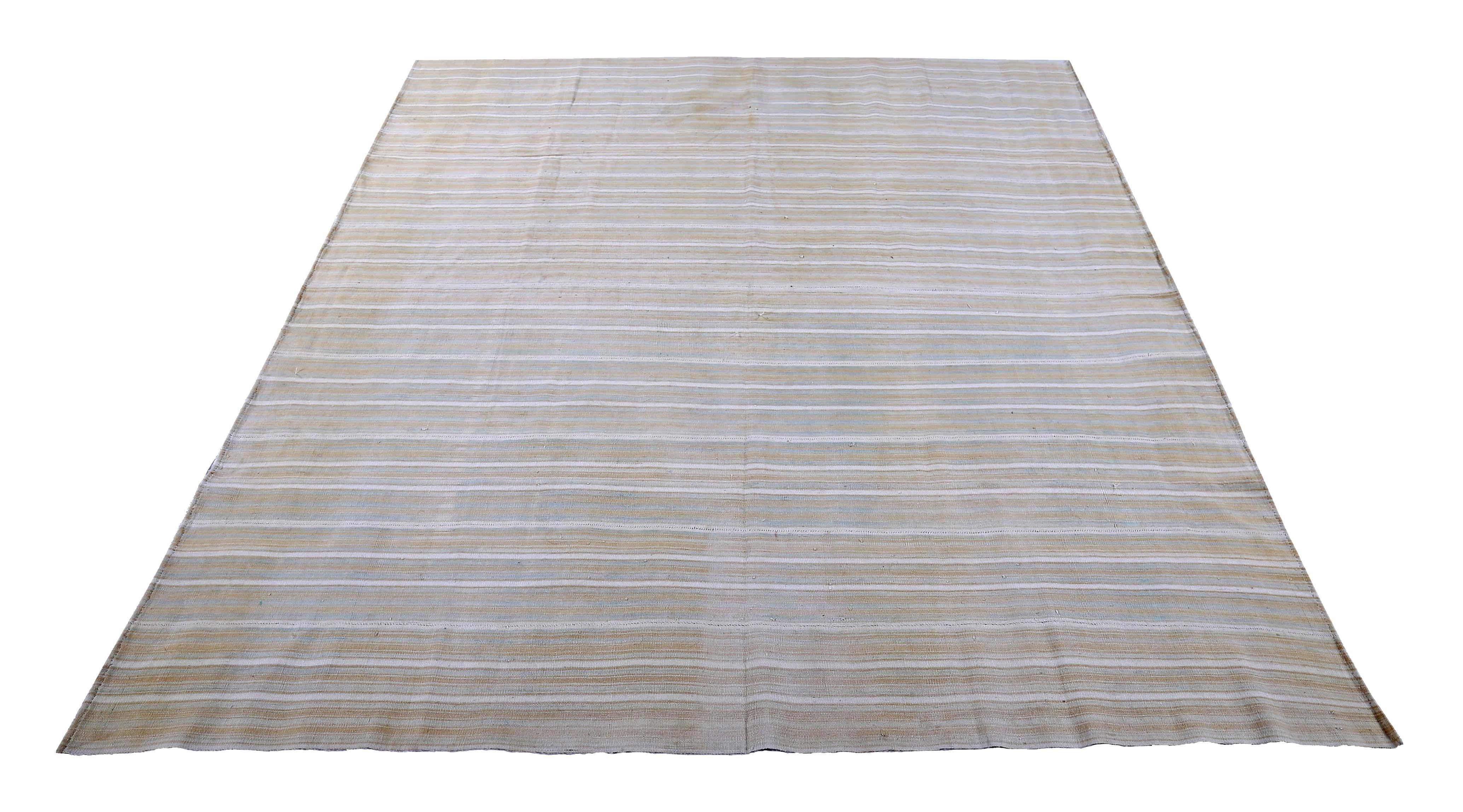 Turkish runner rug handwoven from the finest sheep’s wool and colored with all-natural vegetable dyes that are safe for humans and pets. It’s a traditional Kilim flat-weave design featuring gray and beige stripes over an ivory field. It’s a stunning