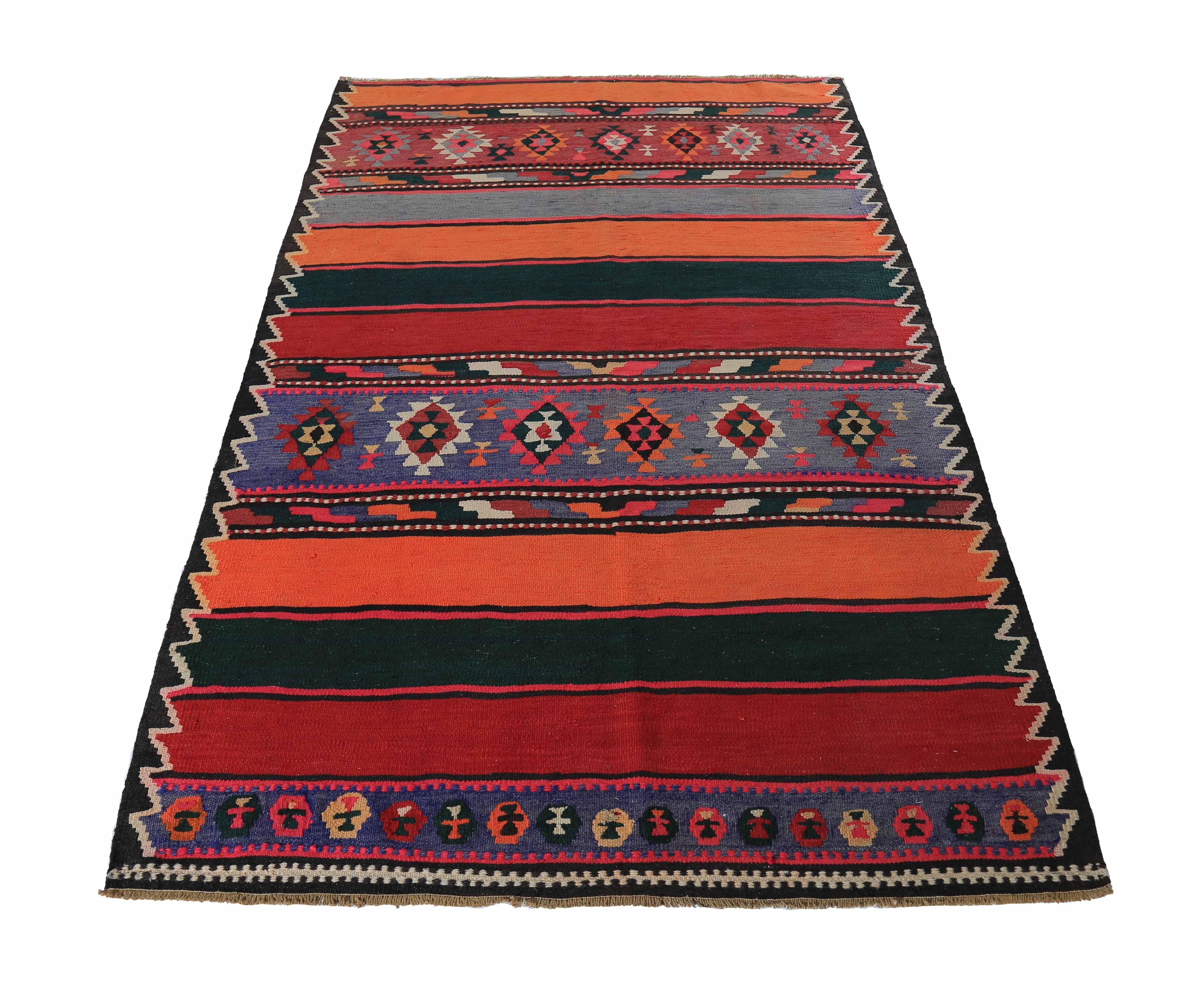 Turkish rug handwoven from the finest sheep’s wool and colored with all-natural vegetable dyes that are safe for humans and pets. It’s a traditional Kilim flat-weave design featuring green and red stripes decorated with tribal medallions. It’s a