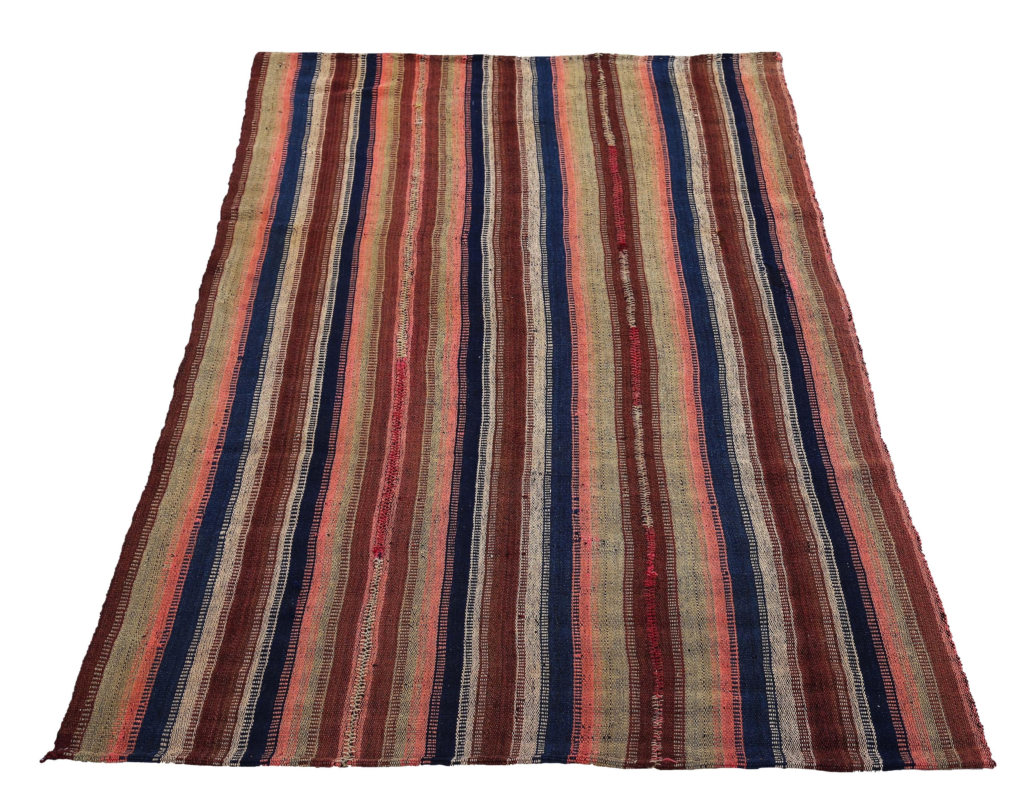 Turkish runner rug handwoven from the finest sheep’s wool and colored with all-natural vegetable dyes that are safe for humans and pets. It’s a traditional Kilim flat-weave design featuring navy blue, brown and pink stripes on an ivory field. It’s a
