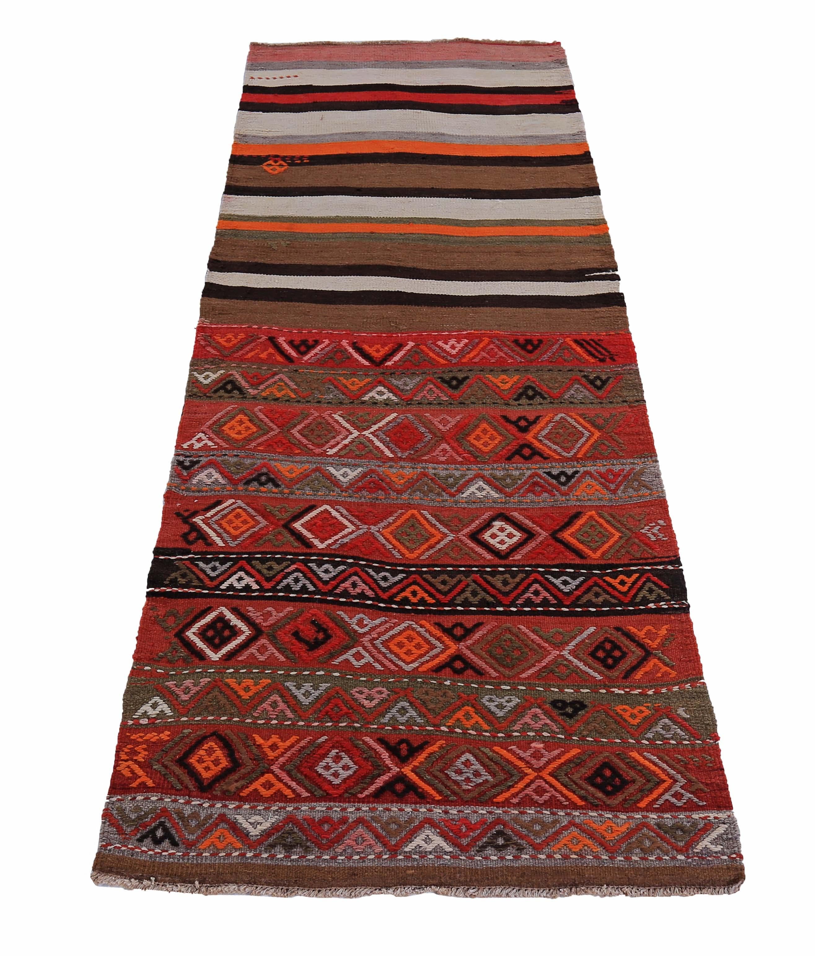 Turkish rug handwoven from the finest sheep’s wool and colored with all-natural vegetable dyes that are safe for humans and pets. It’s a traditional Kilim flat-weave design featuring orange, blue, red and black diamond patterns. It’s a stunning