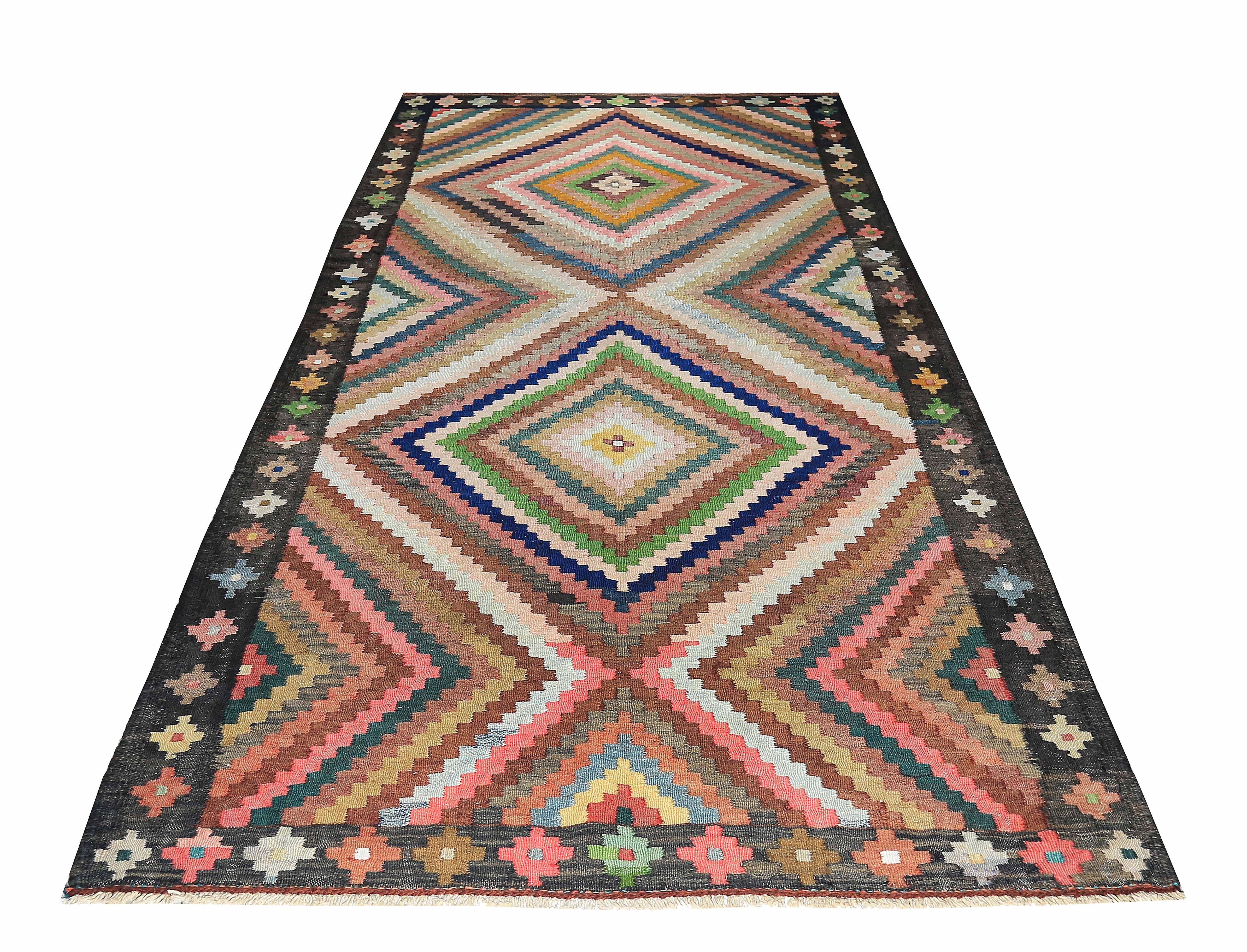 Turkish rug handwoven from the finest sheep’s wool and colored with all-natural vegetable dyes that are safe for humans and pets. It’s a traditional Kilim flat-weave design featuring vibrant colors of tribal medallions and patterns. It’s a stunning