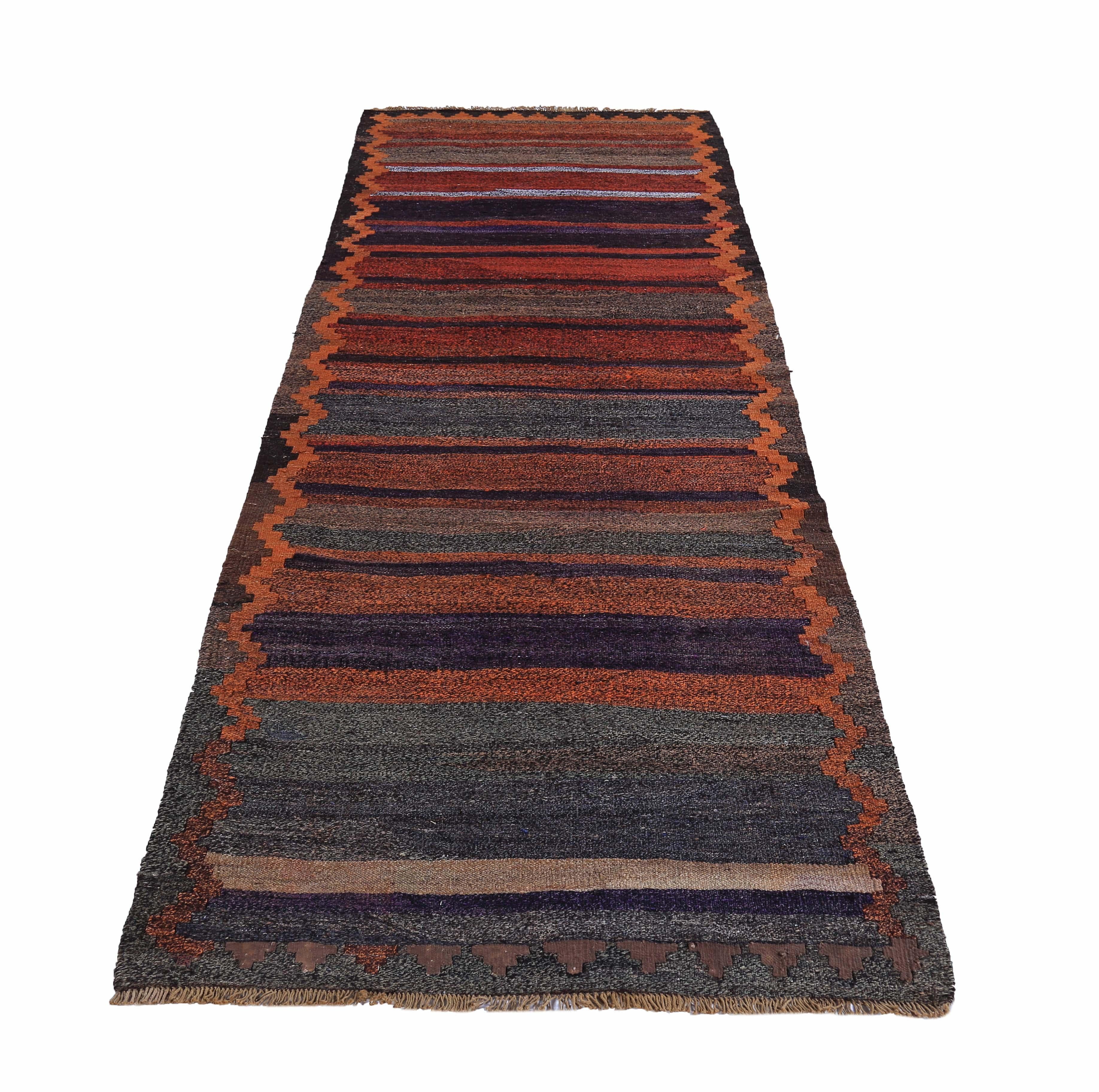 Turkish runner rug handwoven from the finest sheep’s wool and colored with all-natural vegetable dyes that are safe for humans and pets. It’s a traditional Kilim flat-weave design featuring orange, navy and red stripes with tribal patterns. It’s a
