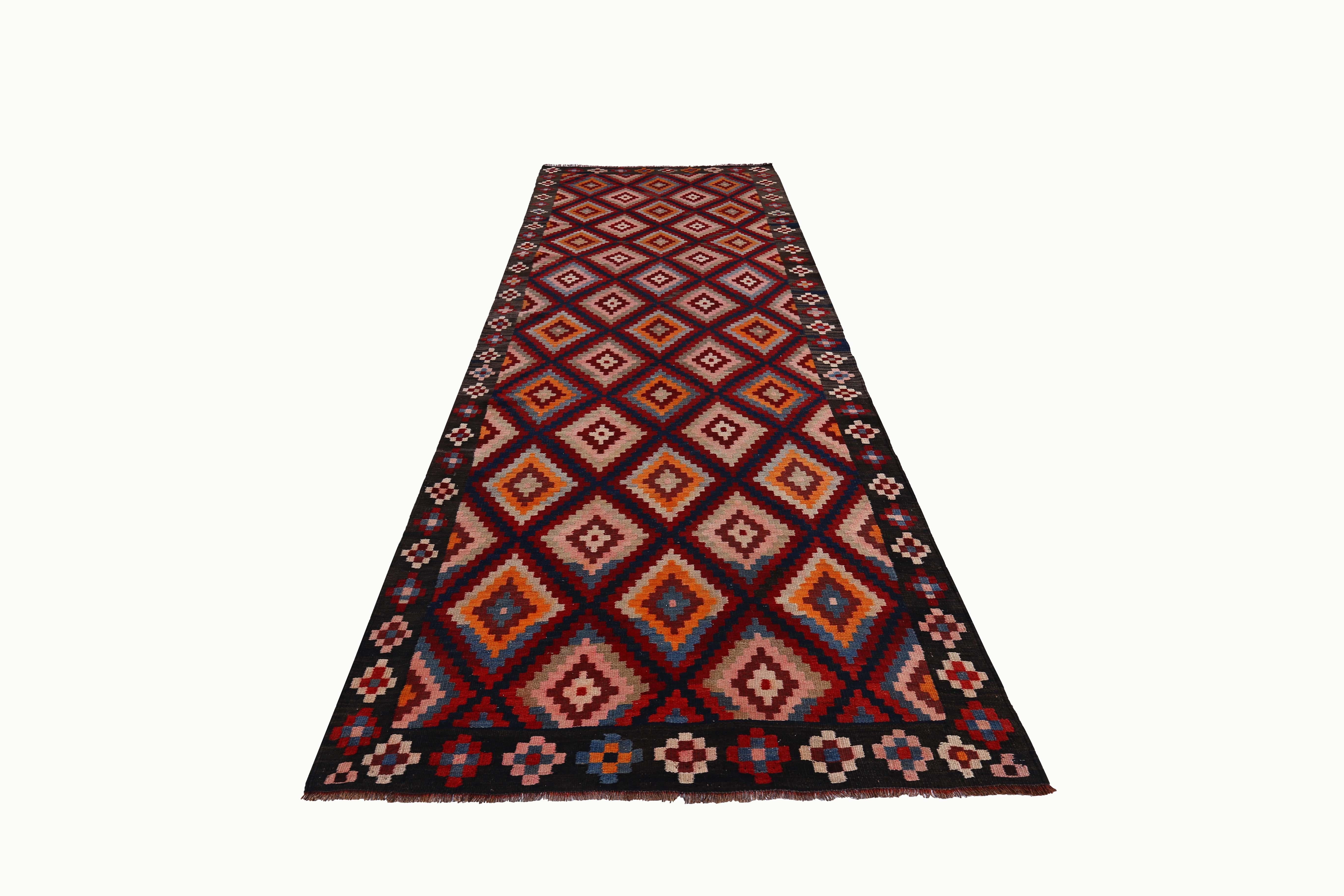 Turkish rug handwoven from the finest sheep’s wool and colored with all-natural vegetable dyes that are safe for humans and pets. It’s a traditional Kilim flat-weave design featuring red, orange and pink diamond design. It’s a stunning piece to get
