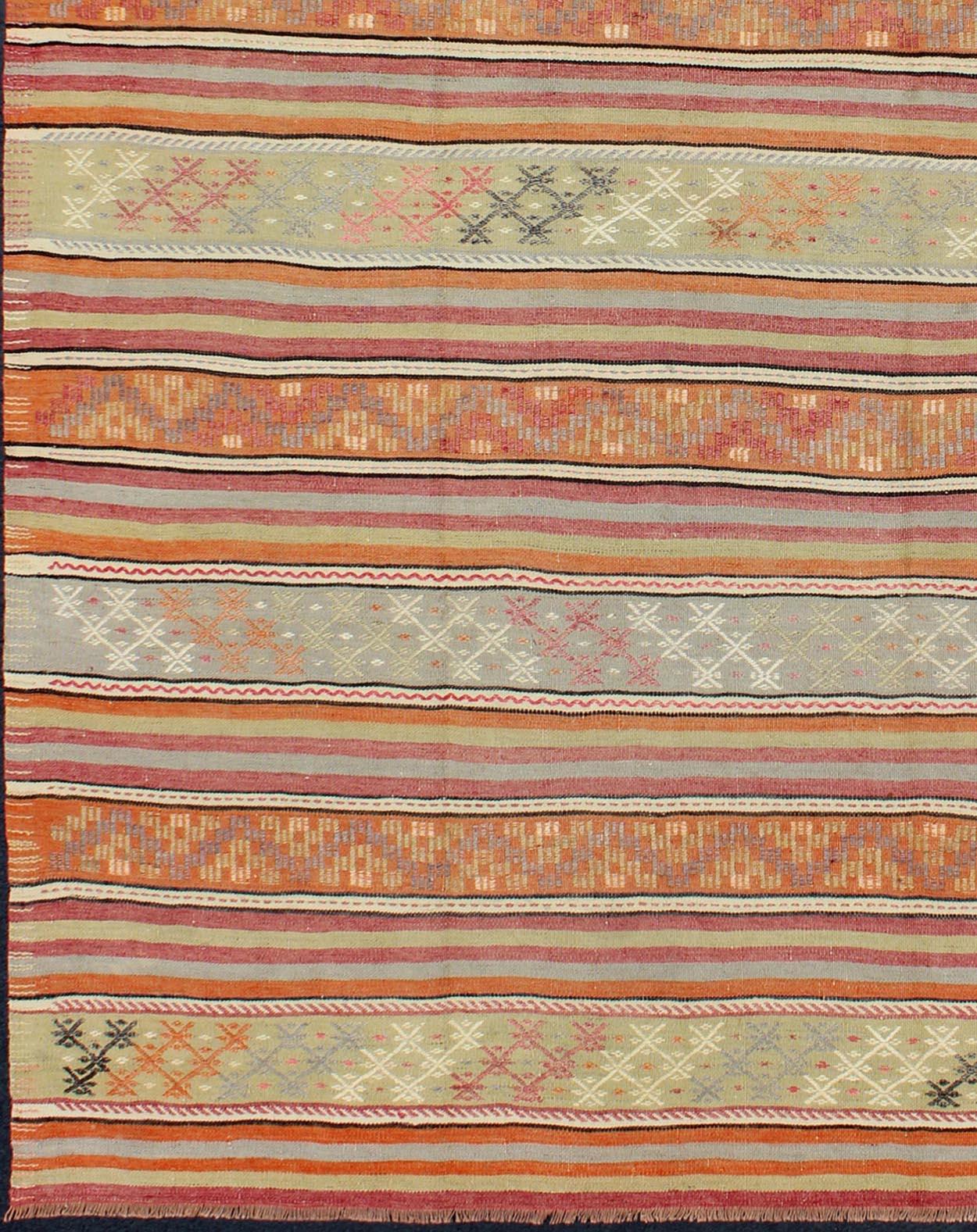 Turkish Kilim vintage rug with assorted stripe design, rug TU-NED-122, country of origin / type: Turkey / Kilim, circa mid-20th century

Featuring a repeating horizontal stripe design, with an assortment of geometric motifs throughout, this unique