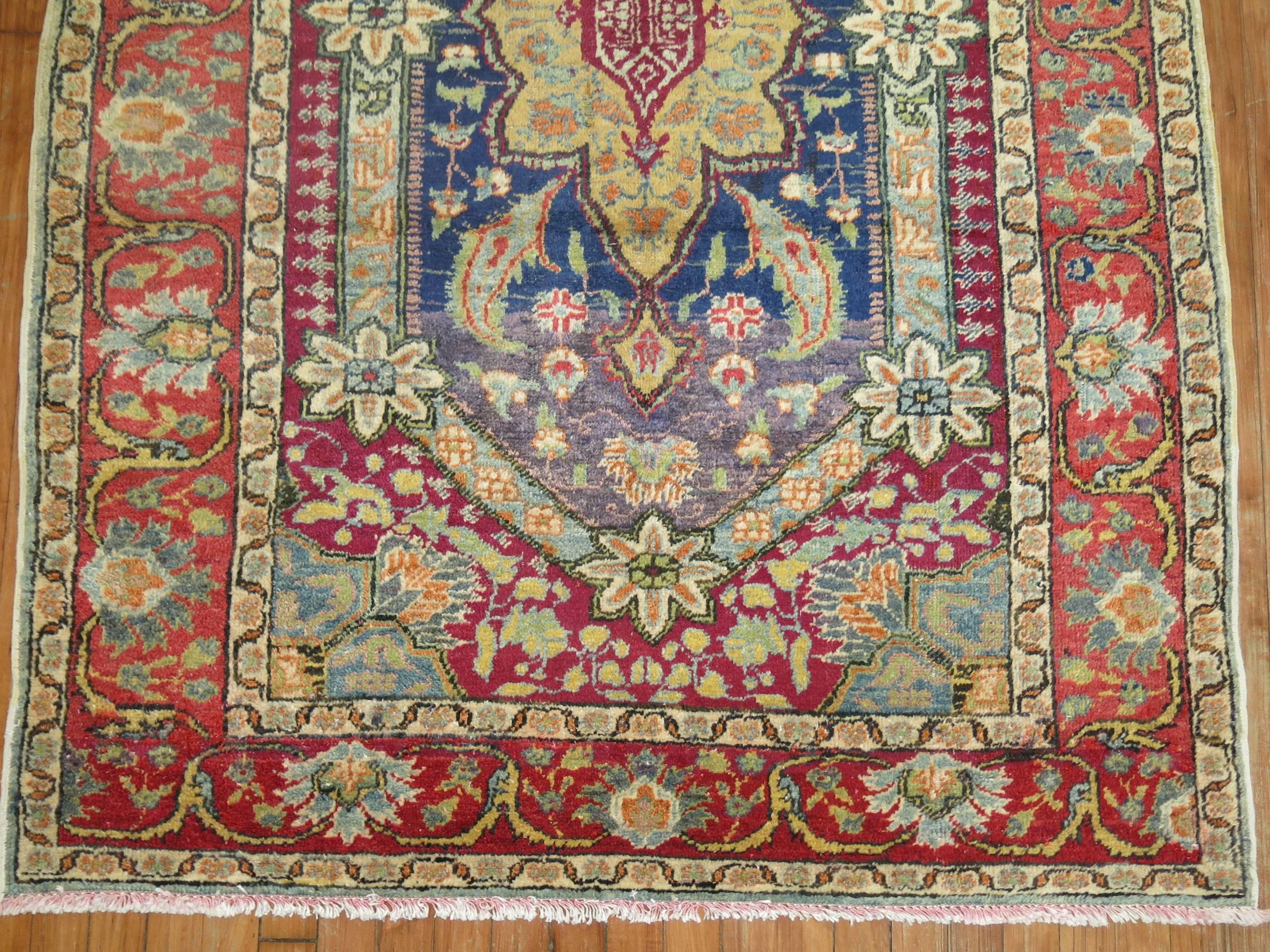 A vintage Turkish Kula Carpet. Predominant accents in blue, red, purple and green.