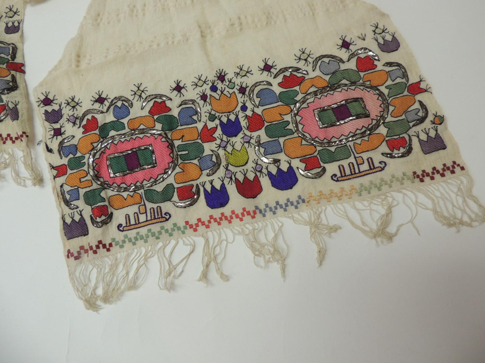 Vintage Turkish linen scarf with heavy embroidery in silk and metallic floss threads
Floral pattern hand embroidered in shades of hot pink, green, red, purple, celedon and black.
Two inches of hand knotted fringes.
Embroidery panels are size 8 x