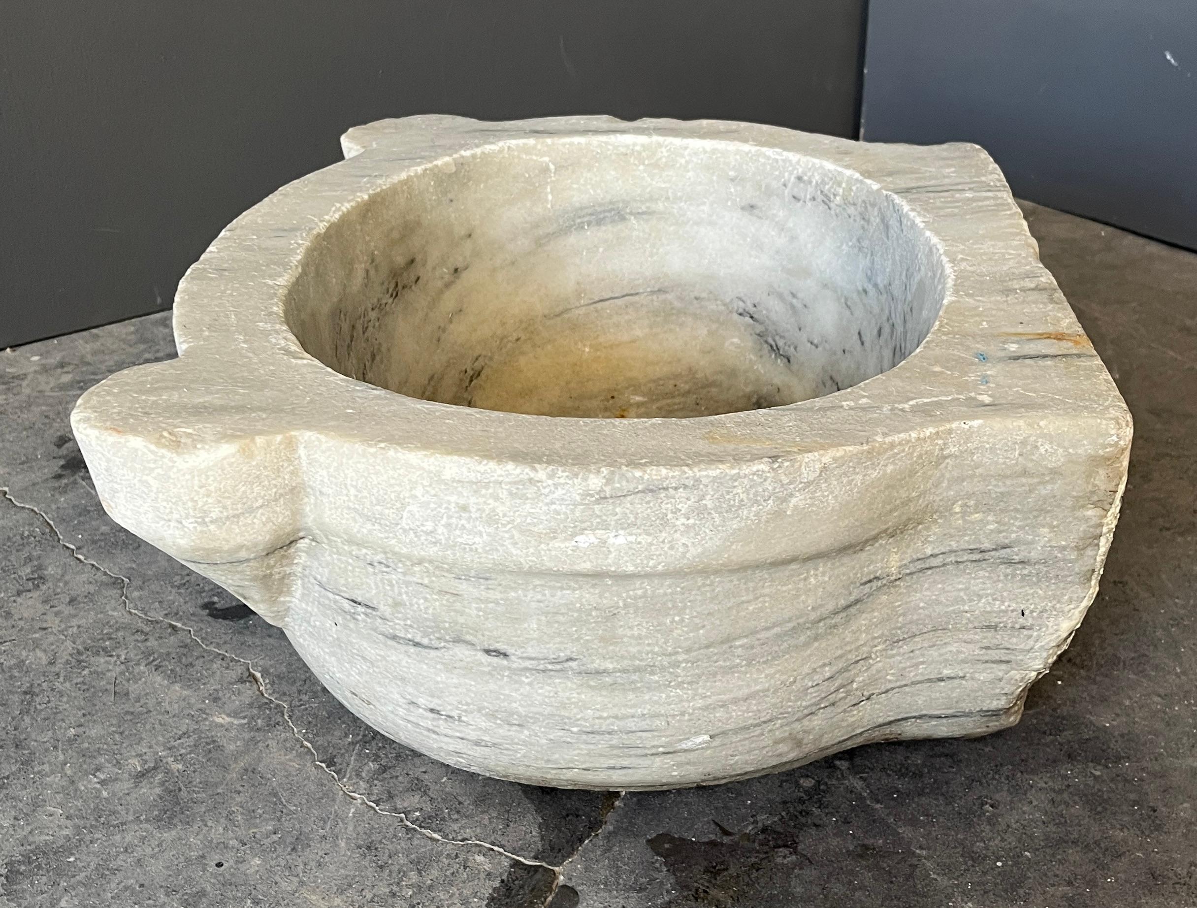 Turkish Marble Sink Crafted from solid marble, this elegant Turkish hammam sink exudes timeless sophistication. Its oval form, softened by years of use, is accented by two subtly protruding stabilizing wings—an architectural detail that nods to