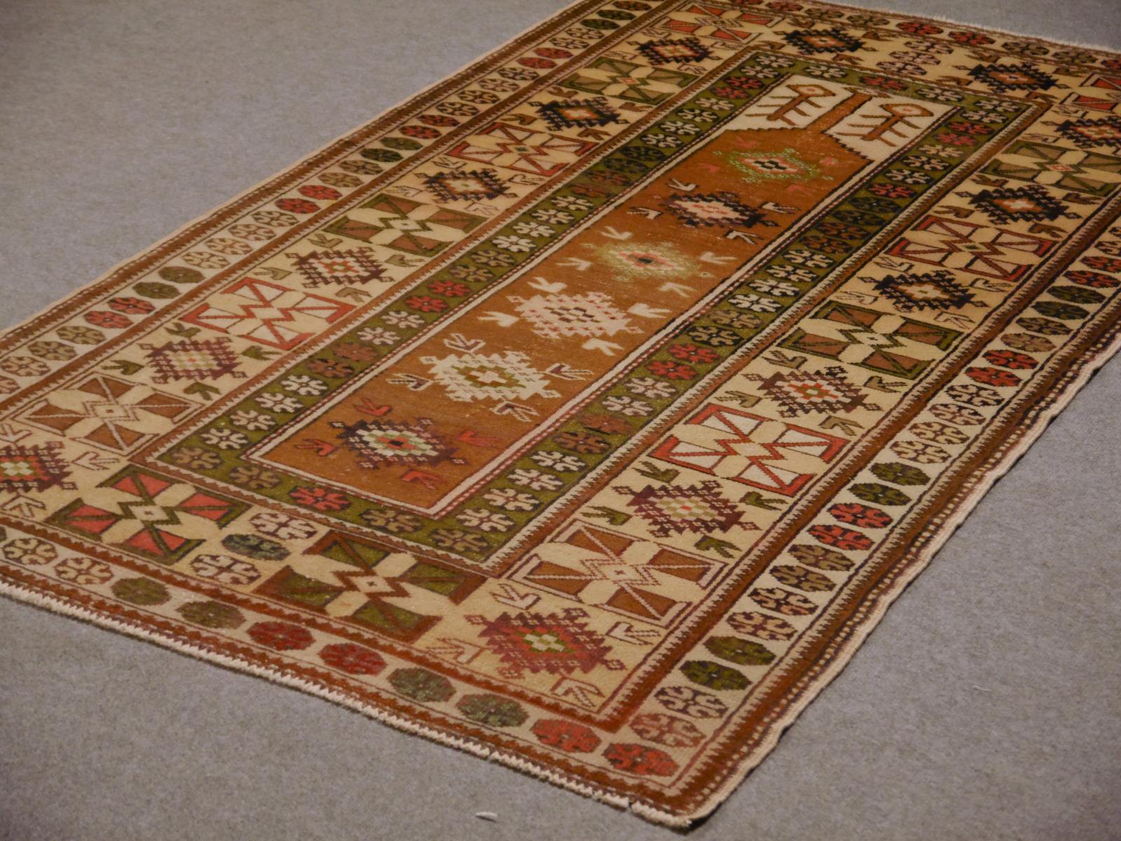 Tribal Turkish Melas rug from western Anatolia. Hand-knotted with fine wool showing a traditional prayer rug design. Very good condition.