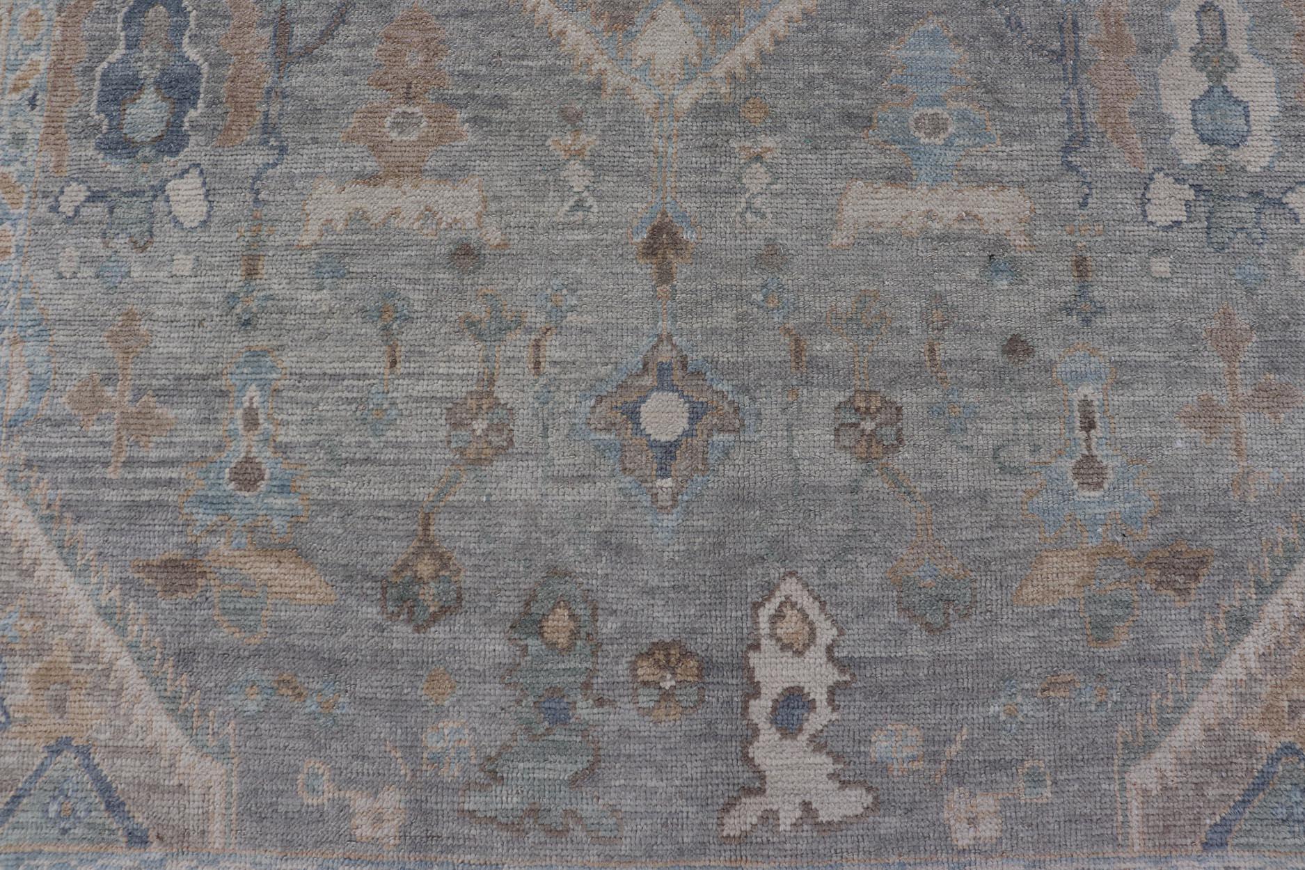 Measures: 7'3 x 10'4 
Turkish Modern Oushak Rug in Medallion Design in Gray-Blue, and Marigold. Keivan Woven Arts / rug EN-15208, country of origin / type: Turkey / Oushak

This traditional Oushak rug from Turkey features a subdued, neutral color