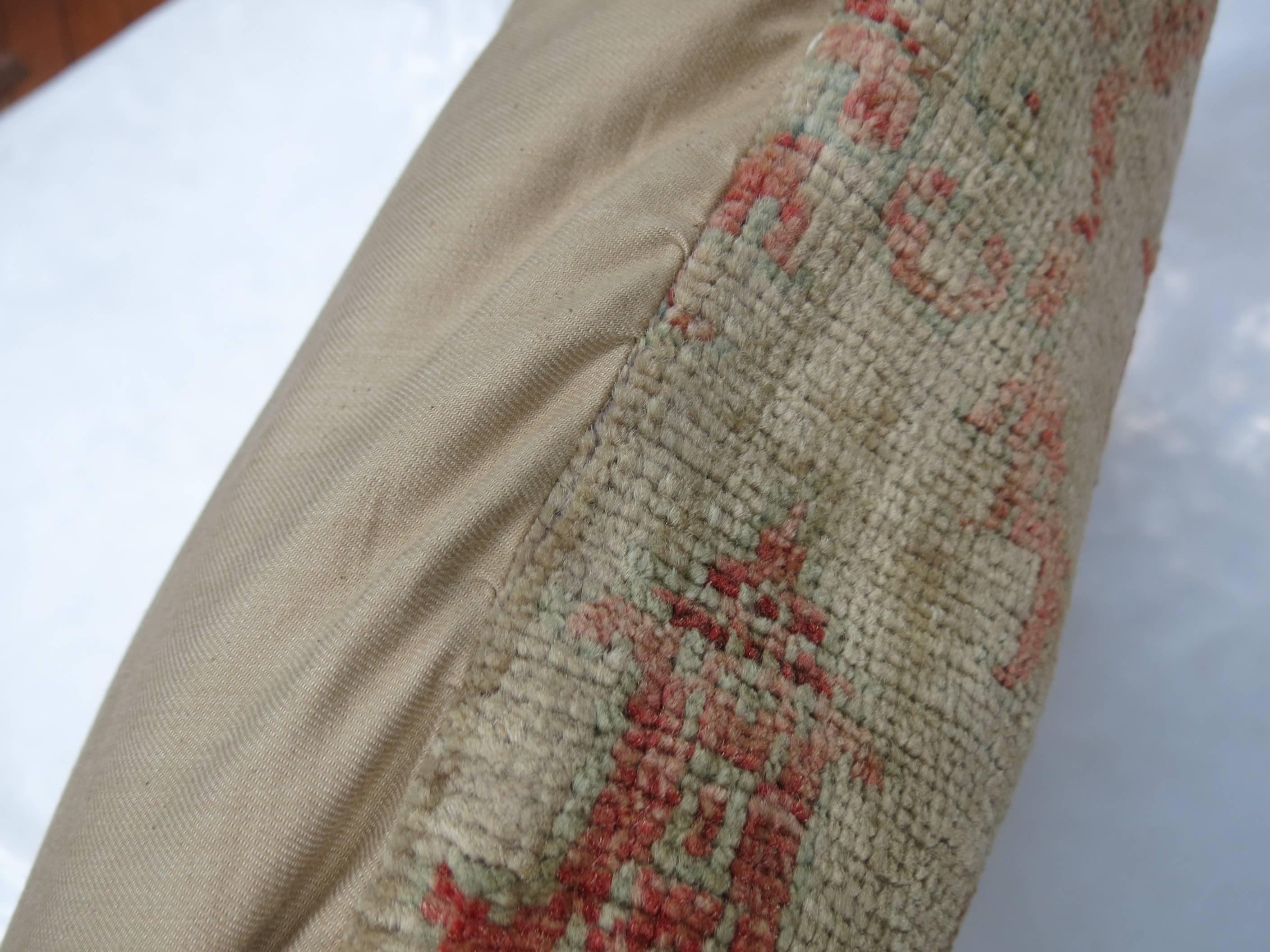 Pillow made from a Vintage Turkish rug in camel and soft red.

19'' x 19''
