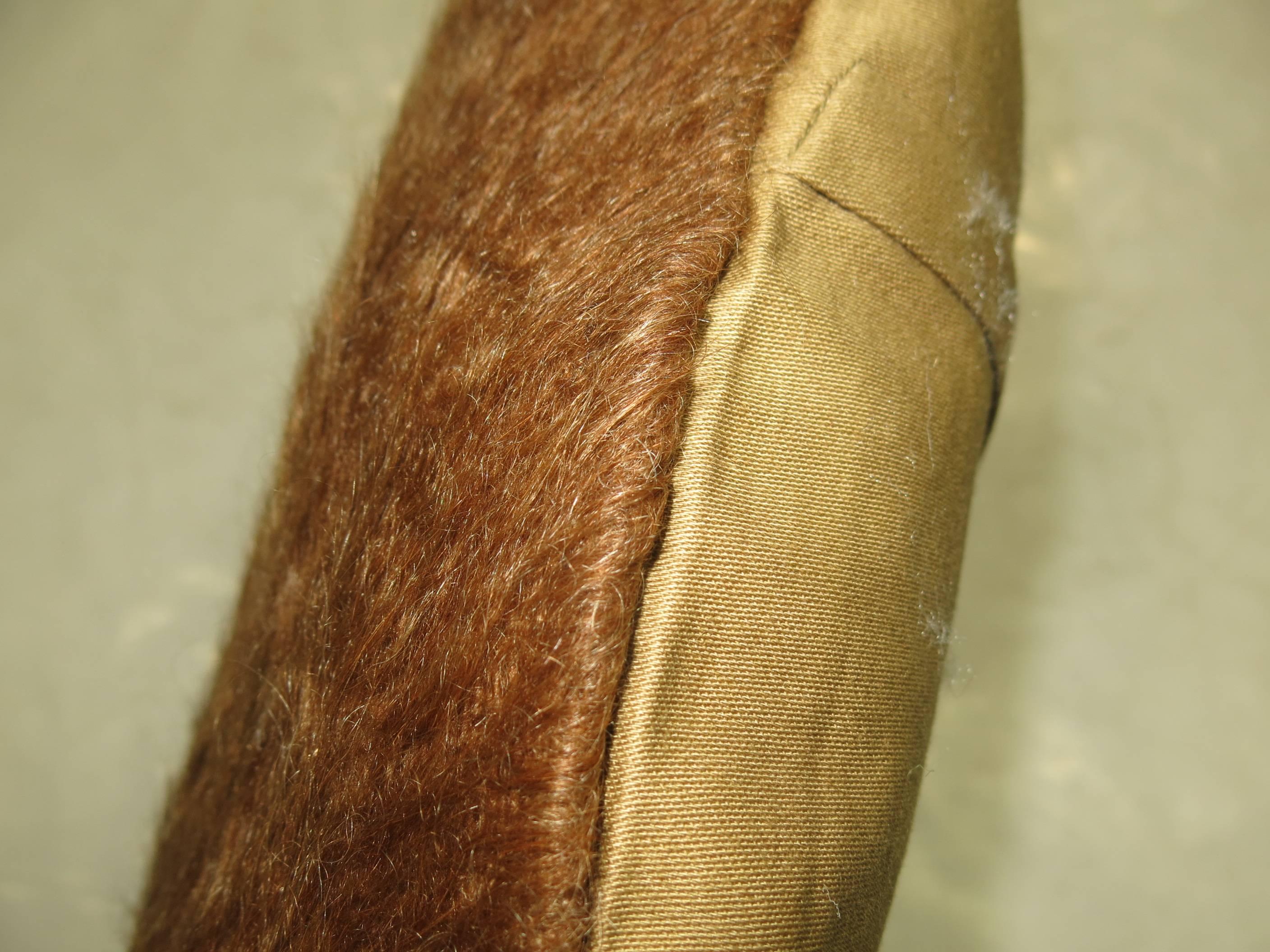 A large pillow made with a brown Turkish Mohair rug.

15'' x 23''