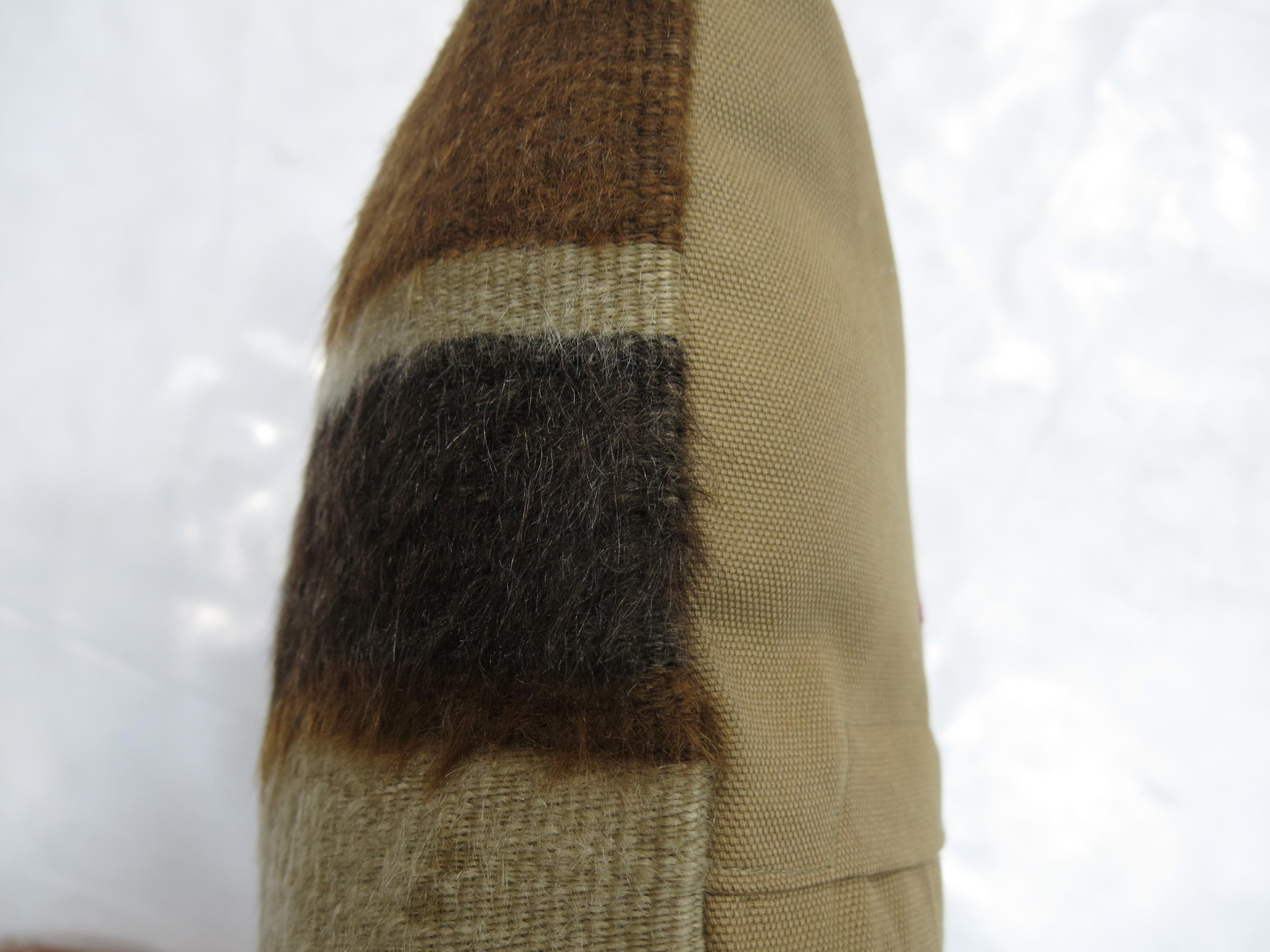 A small pillow made with a brown Turkish Mohair rug.