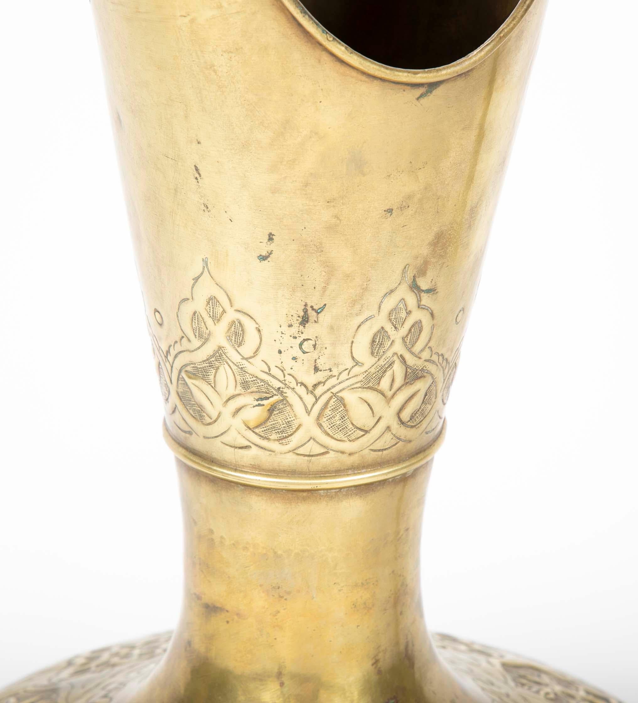 A stunning large-scale Ottoman period brass ewer with incised and repoussé decoration. The scale of this piece is truly impressive and the form so elegant, I have included a picture of the ewer on a side table to give a sense of the impression it