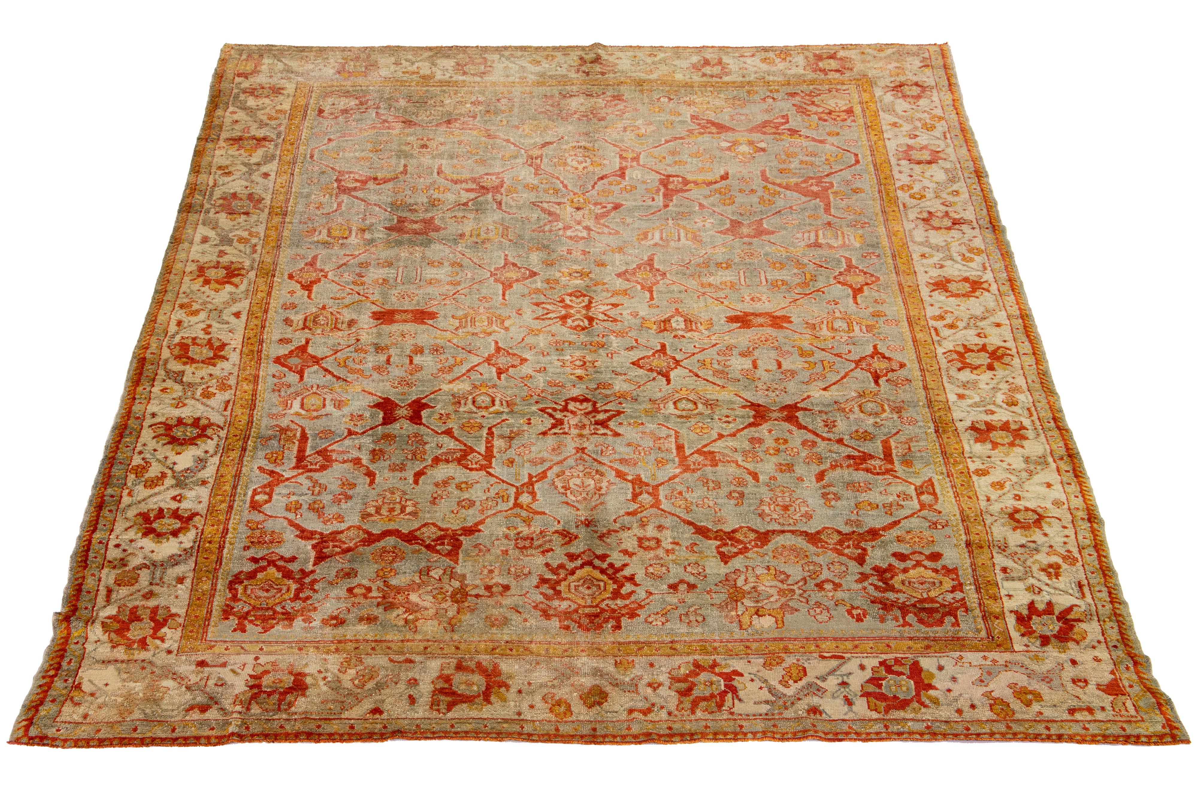 This Turkish Oushak rug is truly one-of-a-kind! Hand-knotted with soft wool, it boasts a stunning gray color field that perfectly complements its striking all-over floral design. With its eye-catching orange-rust and goldenrod accents.

This rug