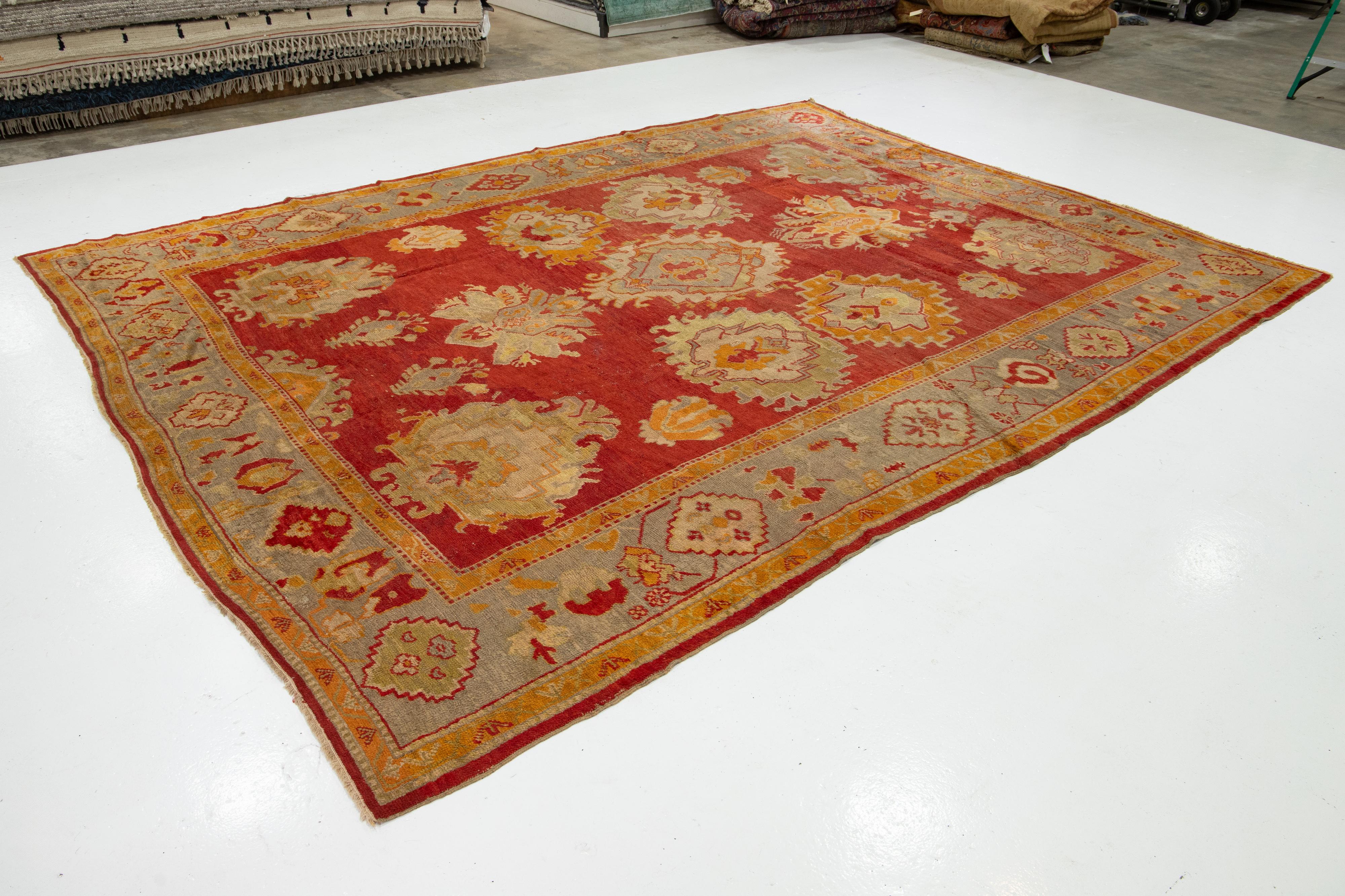 Hand-Knotted Turkish Oushak Antique Wool Rug Handmade In Red Featuring a Floral Design For Sale
