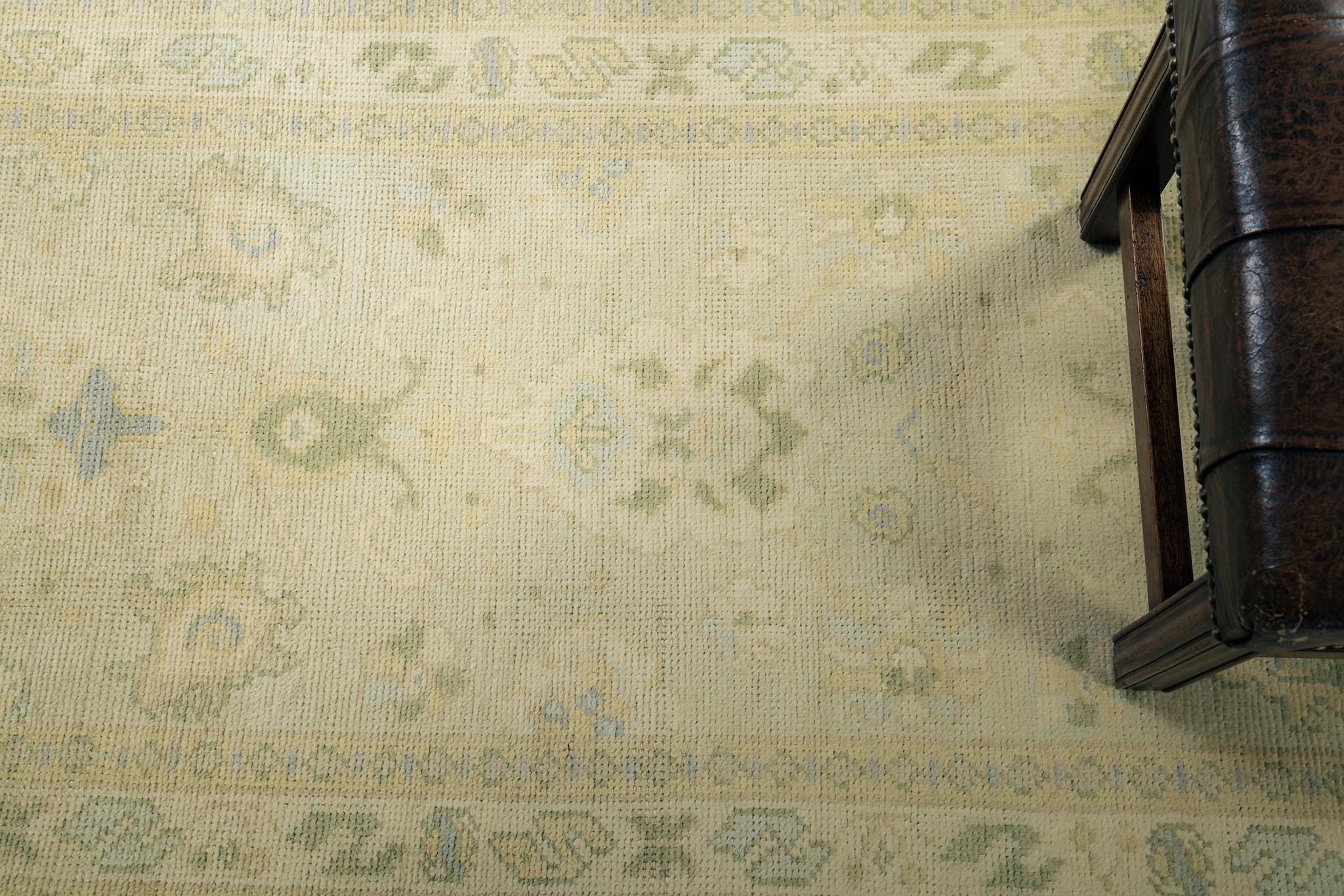 The design accentuates a notable medallion enclosed by patterned motifs. Gold, yellow accents, some shades of blue, and green ornaments predominate in this revival of the Turkish Oushak runner. Adding this masterpiece to your collection will surely