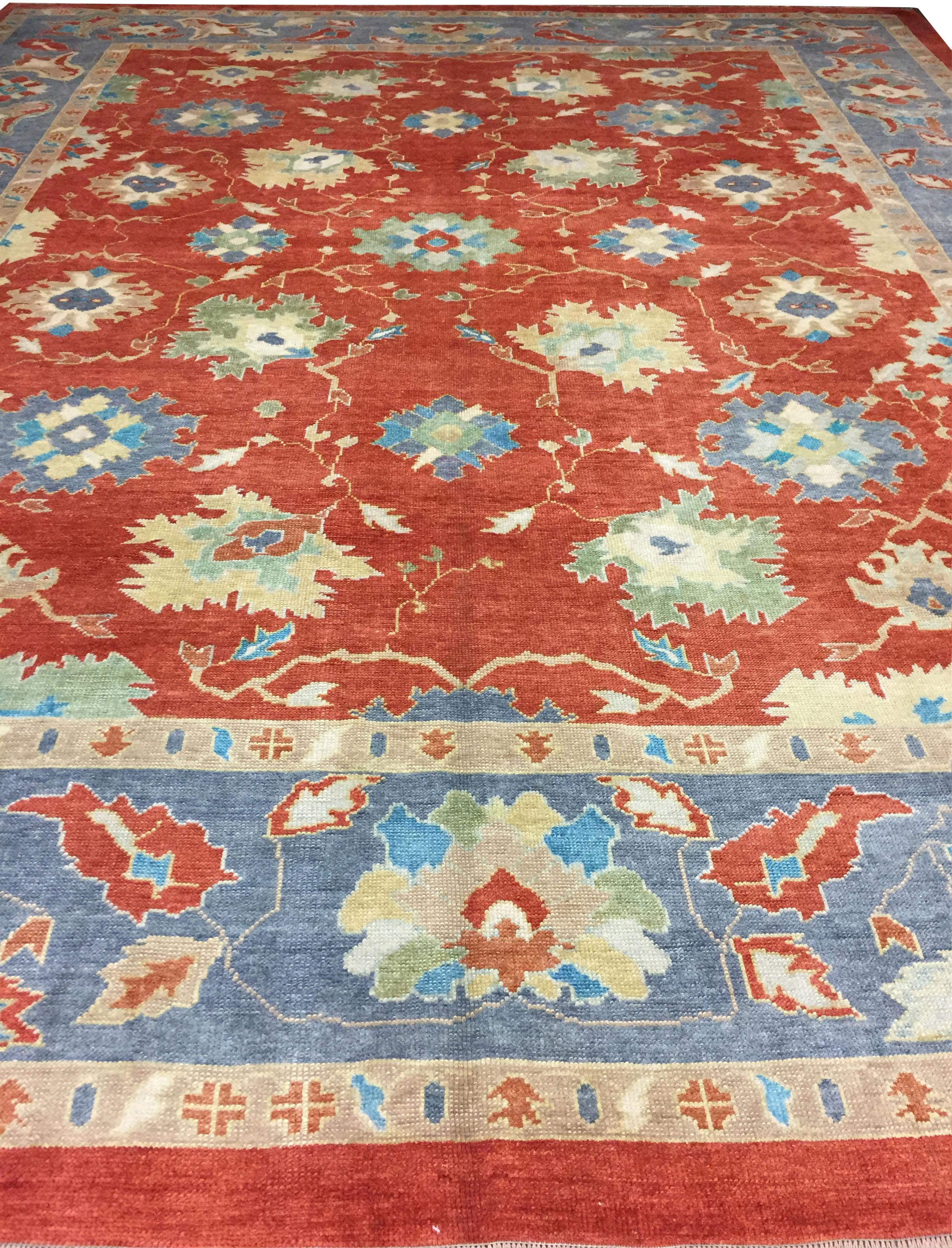Turkish Tomato Oushak rug, 12'10 x 16'1. Character, tradition, pattern and palette converge in this gorgeous new production hand knotted Turkish Oushak rug with soft colors. Colors are tomato/steel blue/soft greens/ivory.