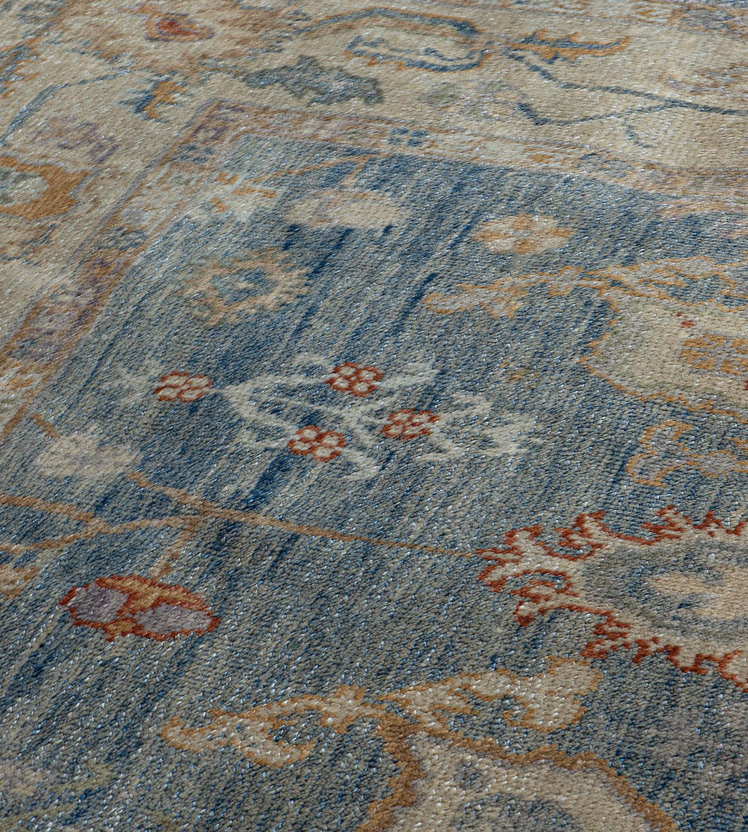 Handwoven by master weavers in Turkey, this magnificently decorative Oushak features a soothing blue color field and a beautiful design with large scale all-over patterns. 100% natural wool pile. Brand new.
 