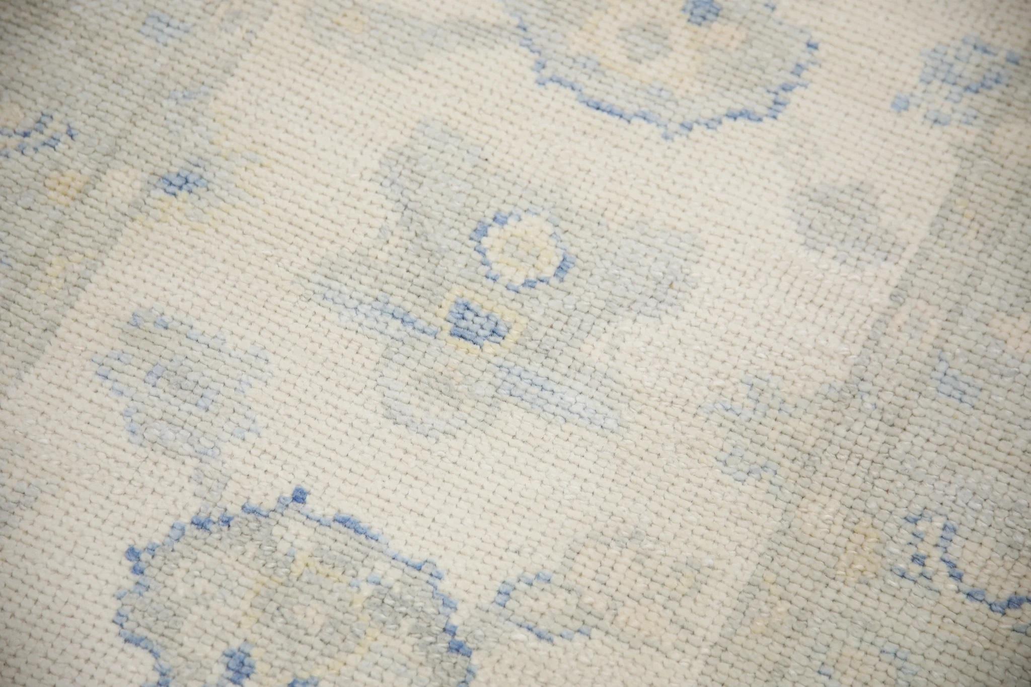 This Turkish oushak rug is a stunning piece of art that has been handwoven using traditional techniques by skilled artisans. The rug features intricate patterns and a soft color palette that is achieved through the use of natural vegetable