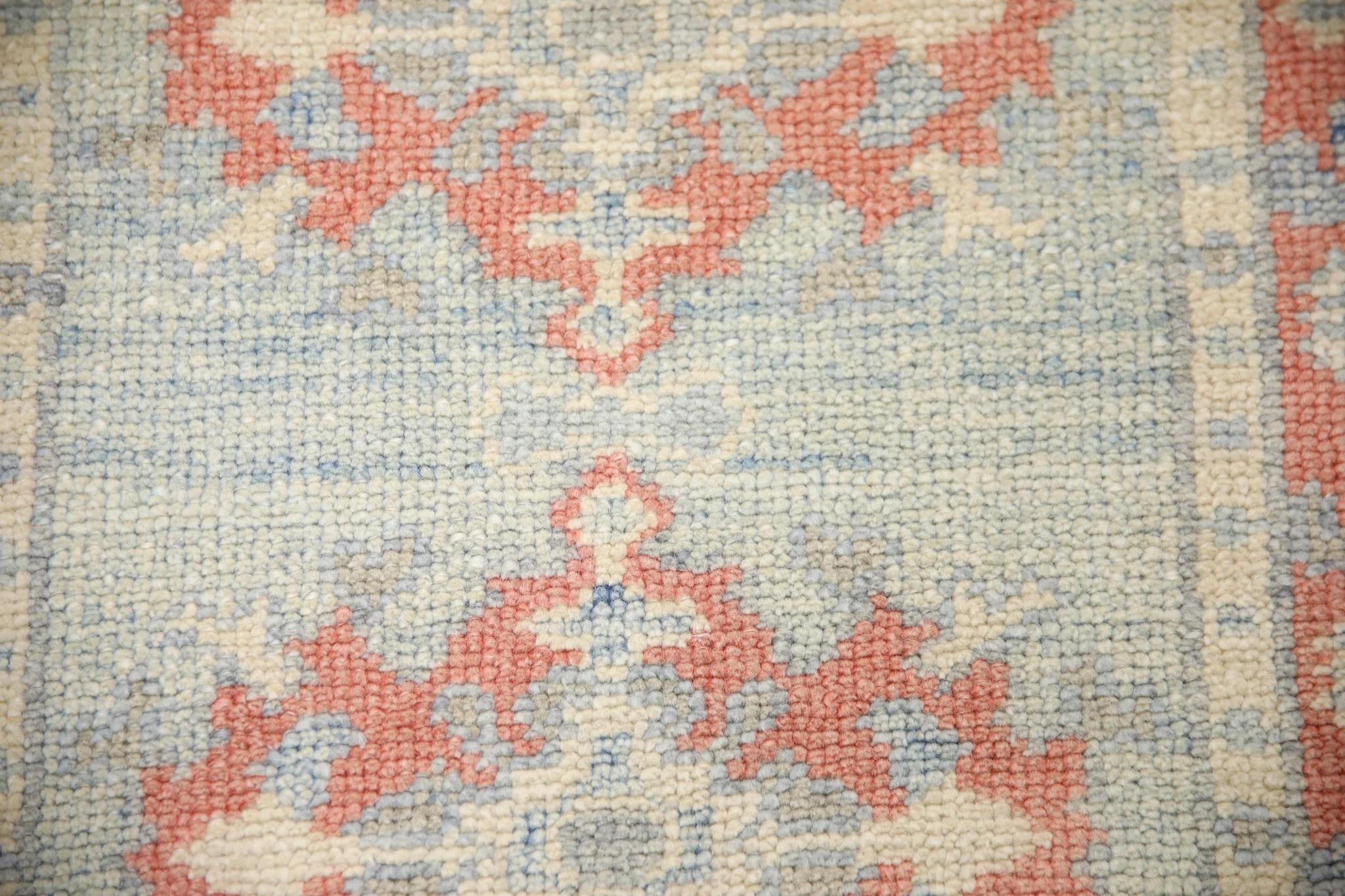 This Turkish Oushak rug is a stunning piece of art that has been handwoven using traditional techniques by skilled artisans. The rug features intricate patterns and a soft color palette that is achieved through the use of natural vegetable