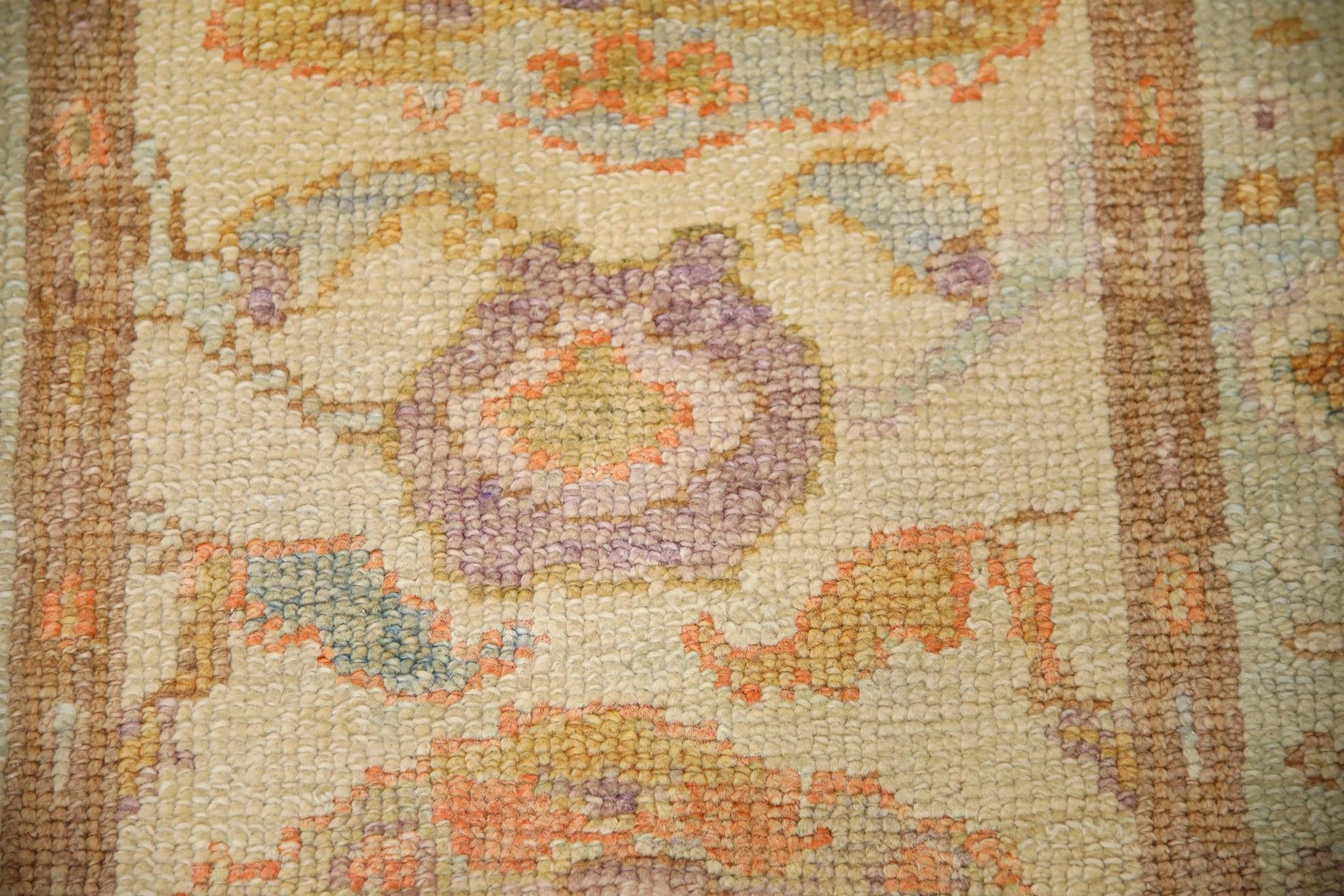 This Turkish oushak rug is a stunning piece of art that has been handwoven using traditional techniques by skilled artisans. The rug features intricate patterns and a soft color palette that is achieved through the use of natural vegetable