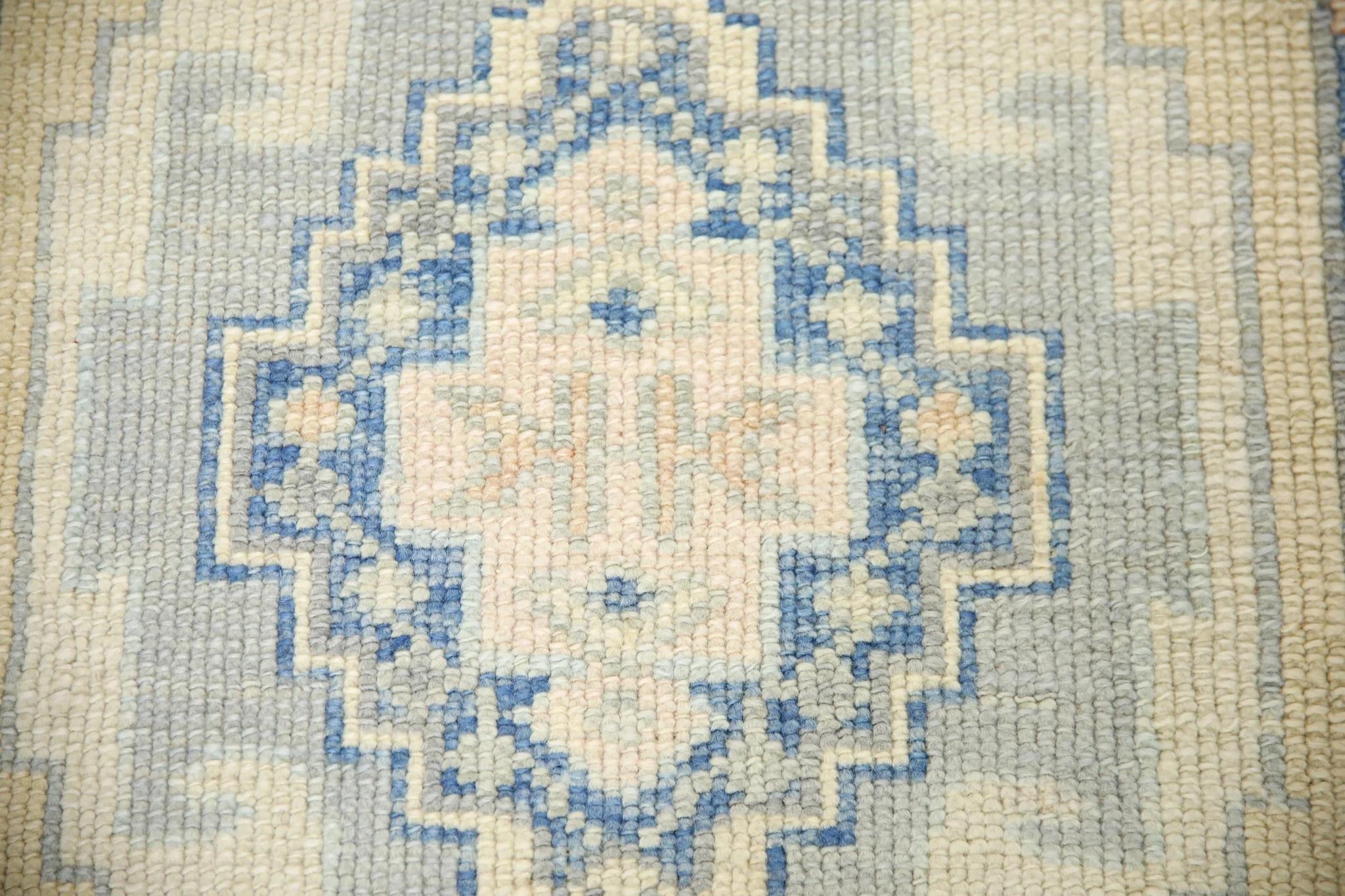 This Turkish oushak rug is a stunning piece of art that has been handwoven using traditional techniques by skilled artisans. The rug features intricate patterns and a soft color palette that is achieved through the use of natural vegetable