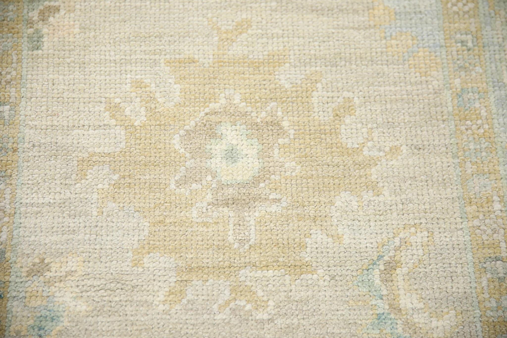 This Turkish oushak rug is a stunning piece of art that has been handwoven using traditional techniques by skilled artisans. The rug features intricate patterns and a soft color palette that is achieved through the use of natural vegetable