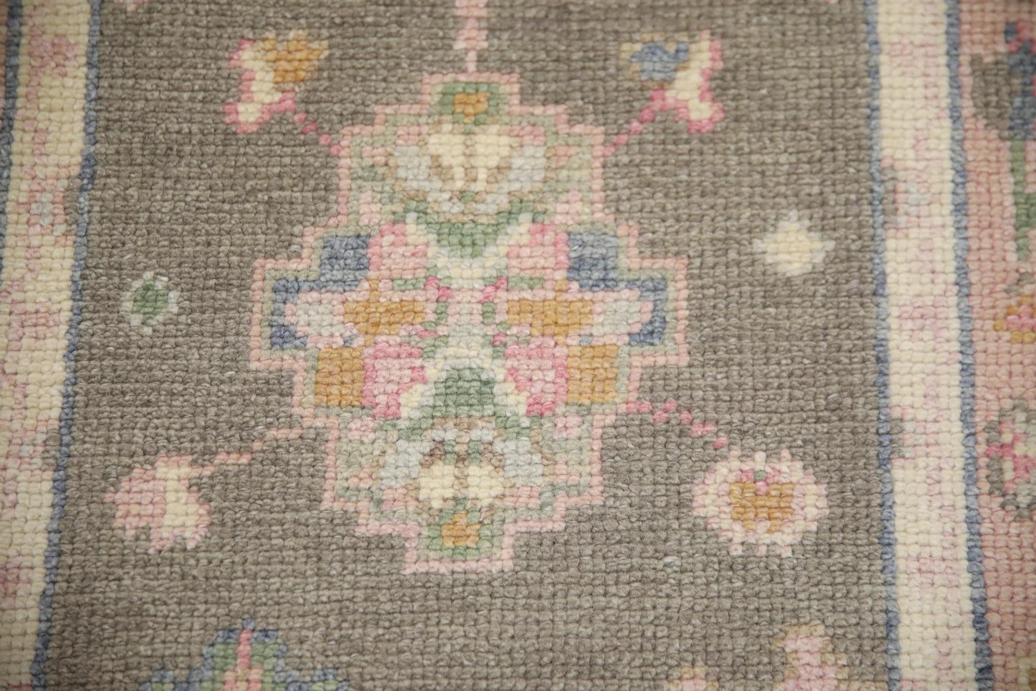This Turkish oushak rug is a stunning piece of art that has been handwoven using traditional techniques by skilled artisans. The rug features intricate patterns and a soft color palette that is achieved through the use of natural vegetable