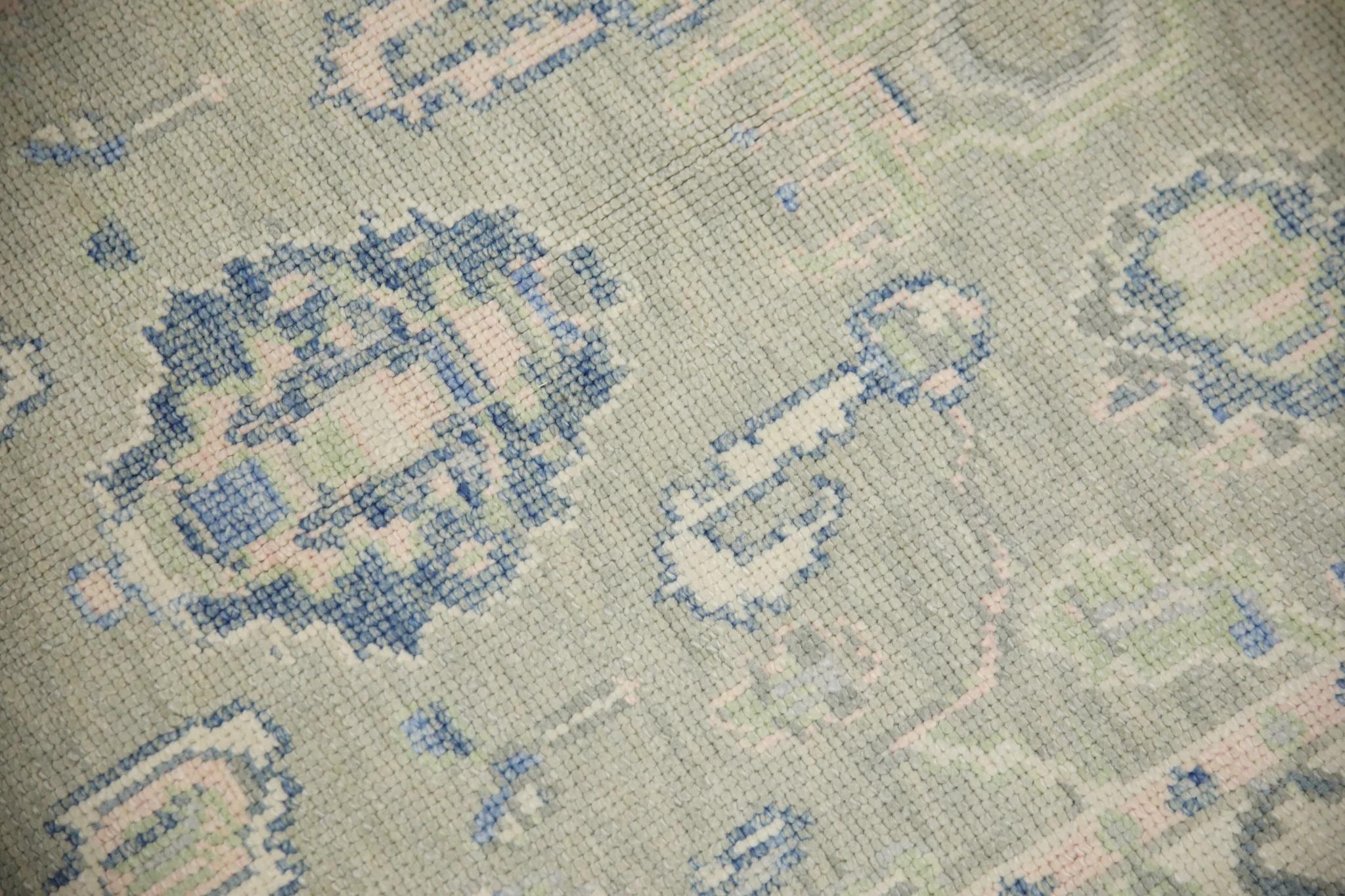 This Turkish oushak rug is a stunning piece of art that has been handwoven using traditional techniques by skilled artisans. The rug features intricate patterns and a soft color palette that is achieved through the use of natural vegetable