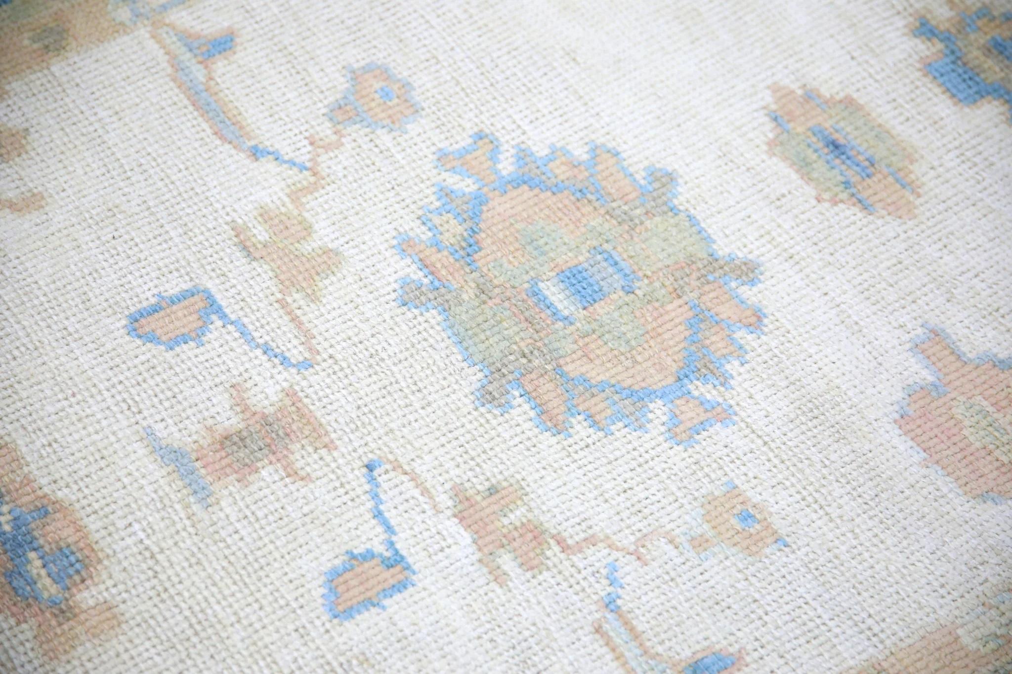 This modern Turkish Oushak rug is a stunning piece of art that has been handwoven using traditional techniques by skilled artisans. The rug features intricate patterns and a soft color palette that is achieved through the use of natural vegetable