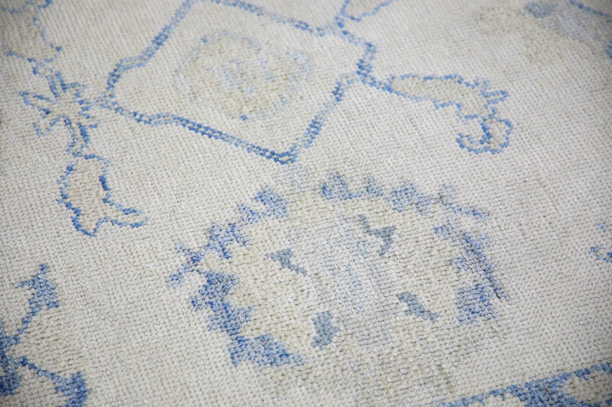 This modern Turkish Oushak rug is a stunning piece of art that has been handwoven using traditional techniques by skilled artisans. The rug features intricate patterns and a soft color palette that is achieved through the use of natural vegetable