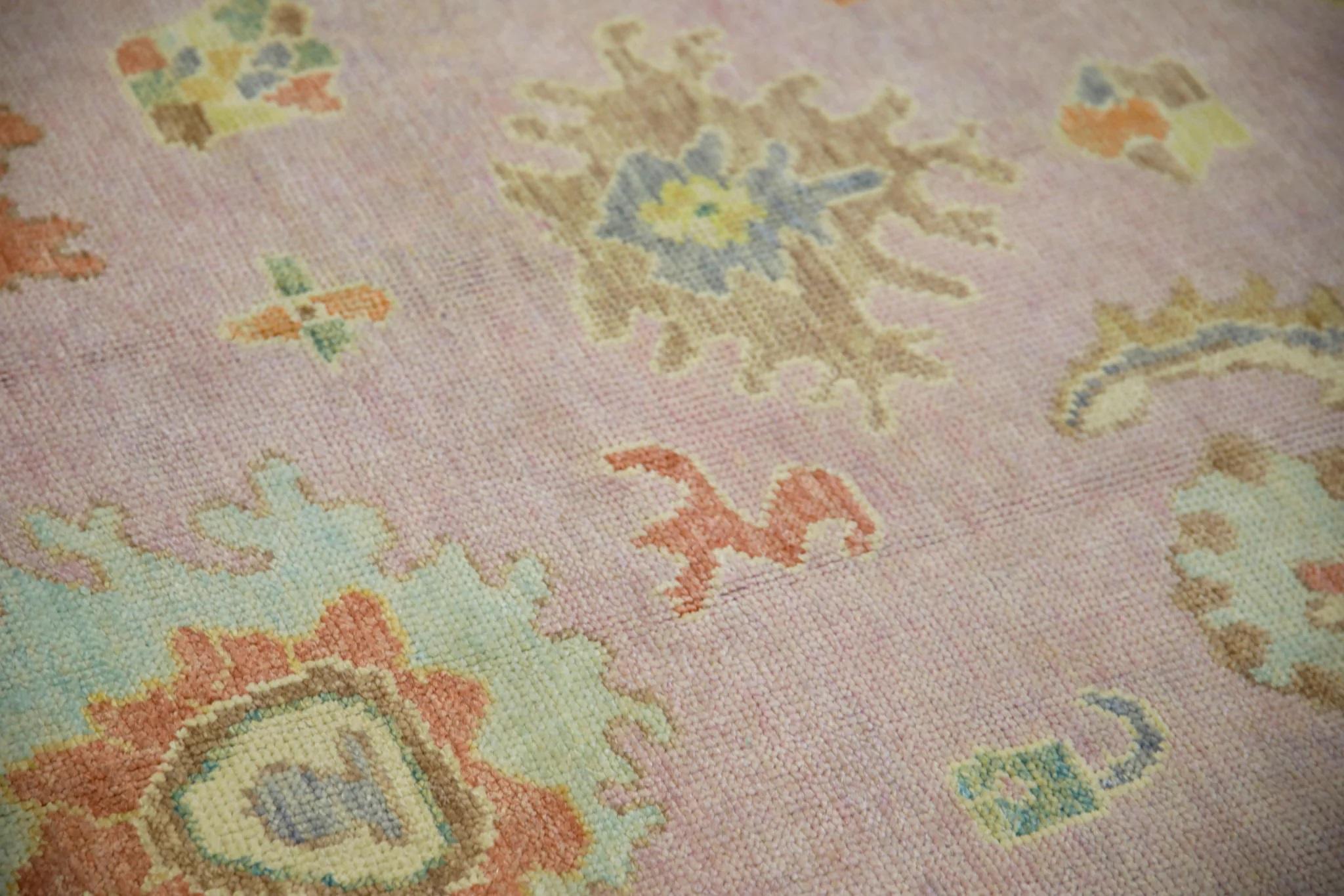 This modern Turkish Oushak rug is a stunning piece of art that has been handwoven using traditional techniques by skilled artisans. The rug features intricate patterns and a soft color palette that is achieved through the use of natural vegetable