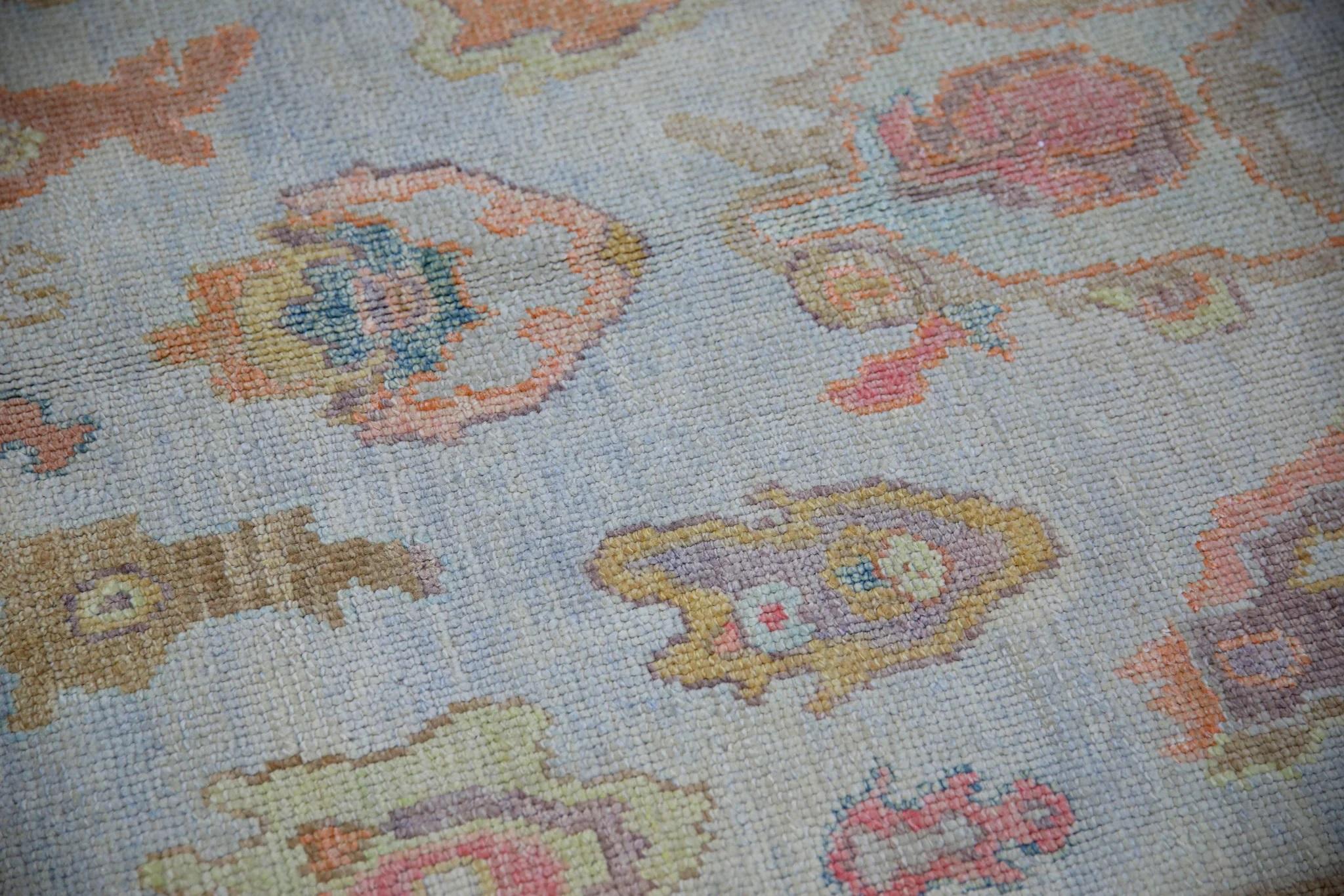 This modern Turkish Oushak rug is a stunning piece of art that has been handwoven using traditional techniques by skilled artisans. The rug features intricate patterns and a soft color palette that is achieved through the use of natural vegetable