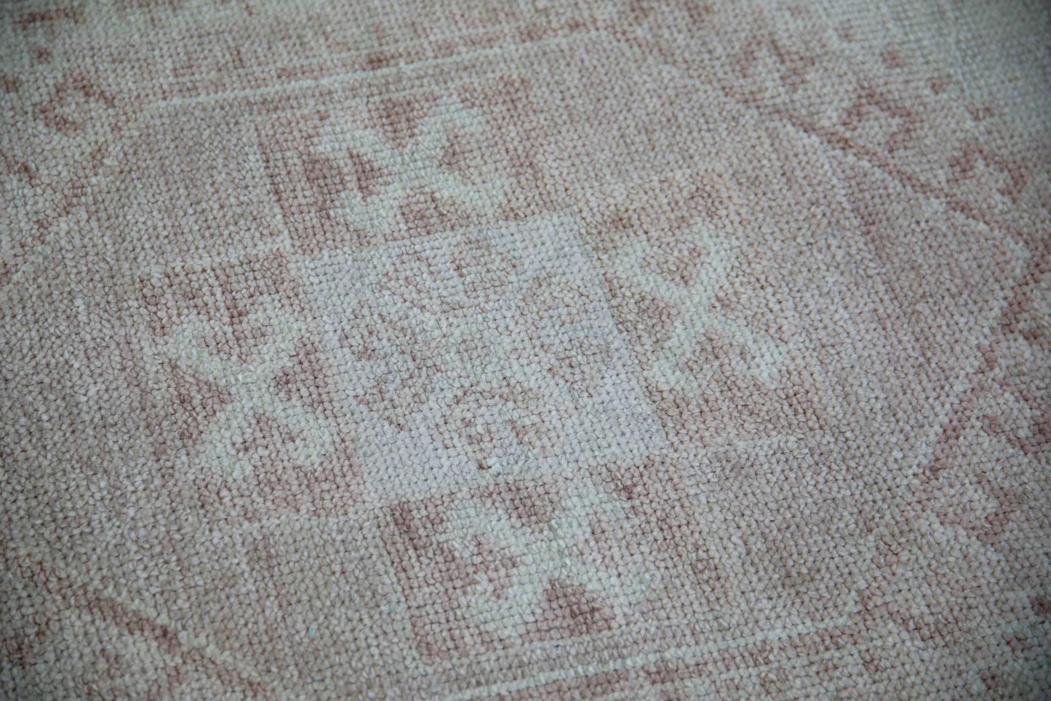 This modern Turkish Oushak rug is a stunning piece of art that has been handwoven using traditional techniques by skilled artisans. The rug features intricate patterns and a soft color palette that is achieved through the use of natural vegetable