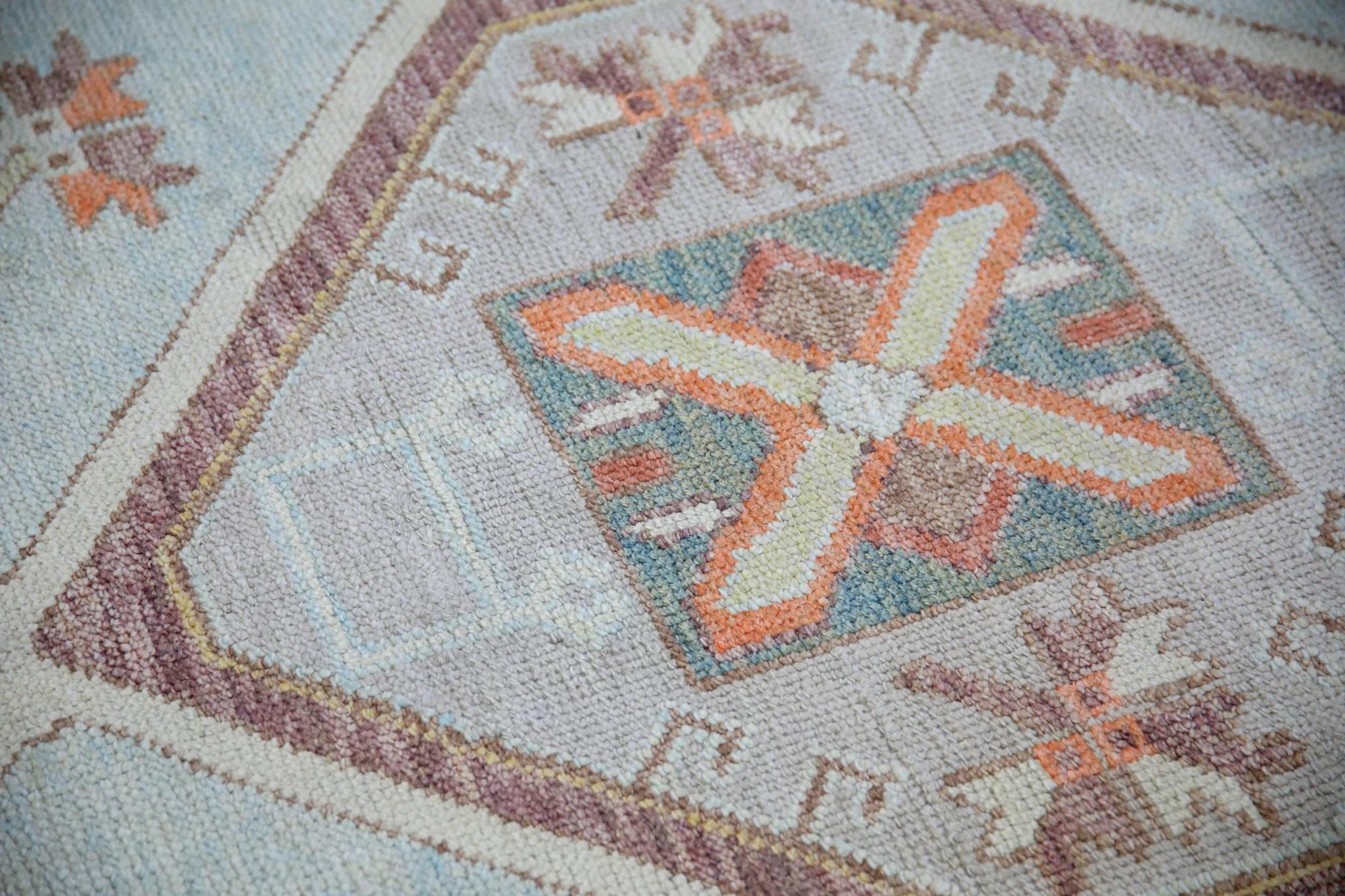 This modern Turkish Oushak rug is a stunning piece of art that has been handwoven using traditional techniques by skilled artisans. The rug features intricate patterns and a soft color palette that is achieved through the use of natural vegetable