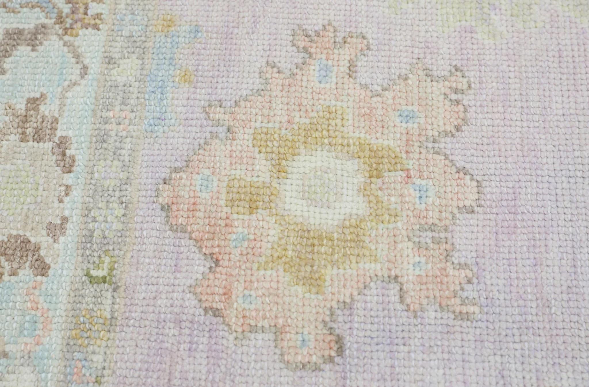 This modern Turkish Oushak rug is a stunning piece of art that has been handwoven using traditional techniques by skilled artisans. The rug features intricate patterns and a soft color palette that is achieved through the use of natural vegetable