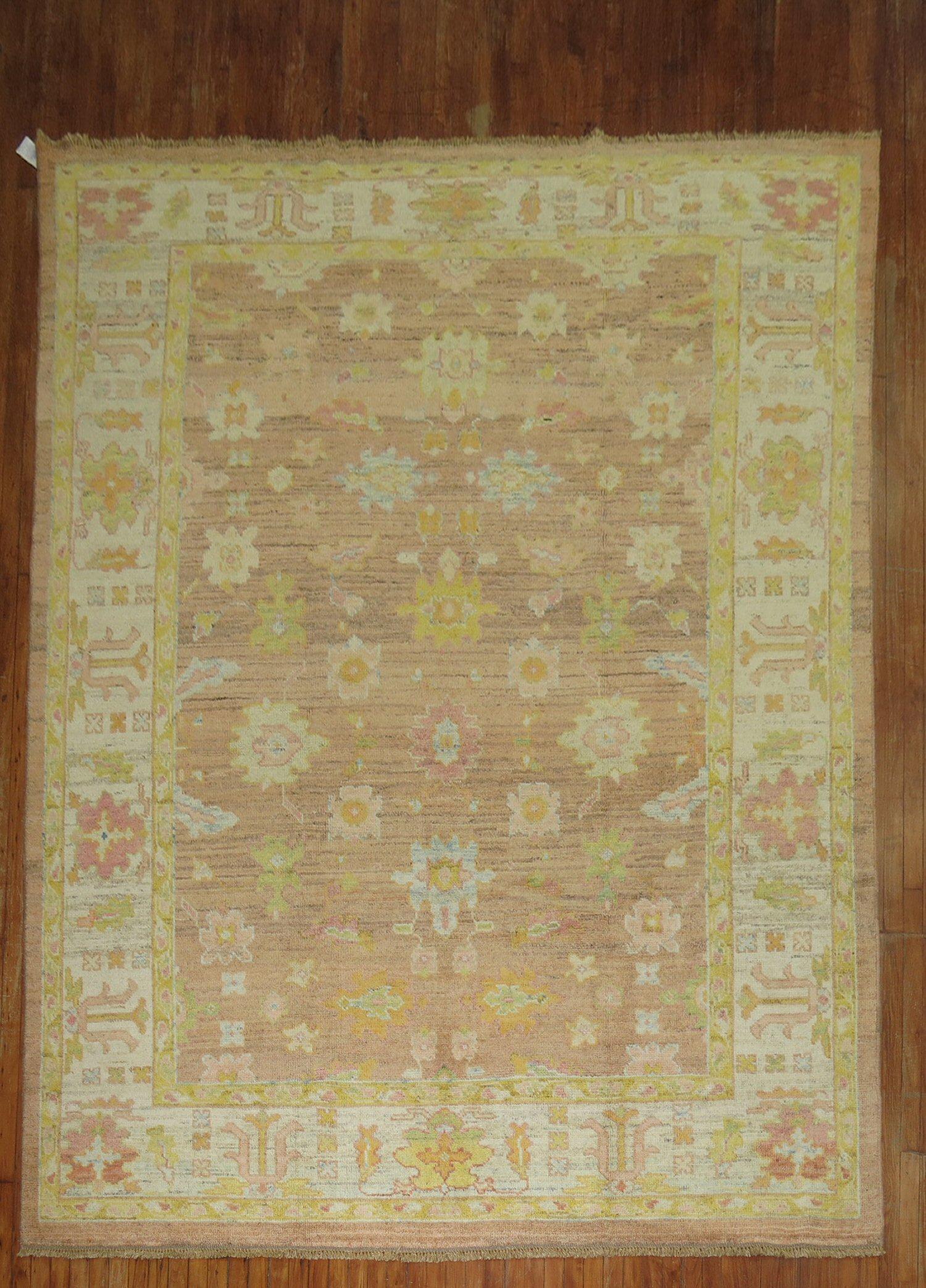 One of a kind wool Turkish Oushak Rug with citrus and pastel accents on a soft brown field.

Measures: 8'4'' x 11'2''.

 