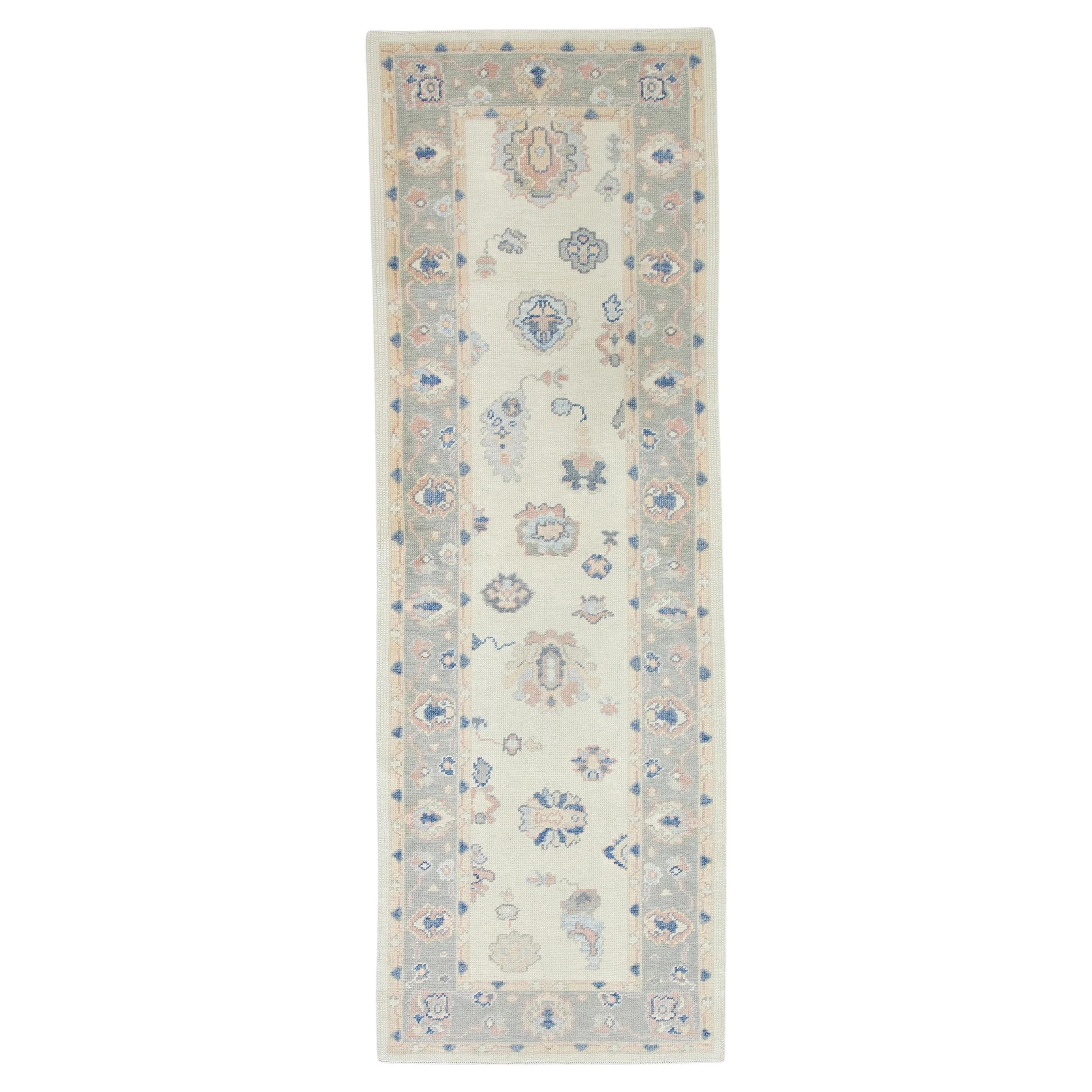 Cream Handwoven Wool Turkish Oushak Rug in Pink & Blue Floral Design 3' x 8'11" For Sale