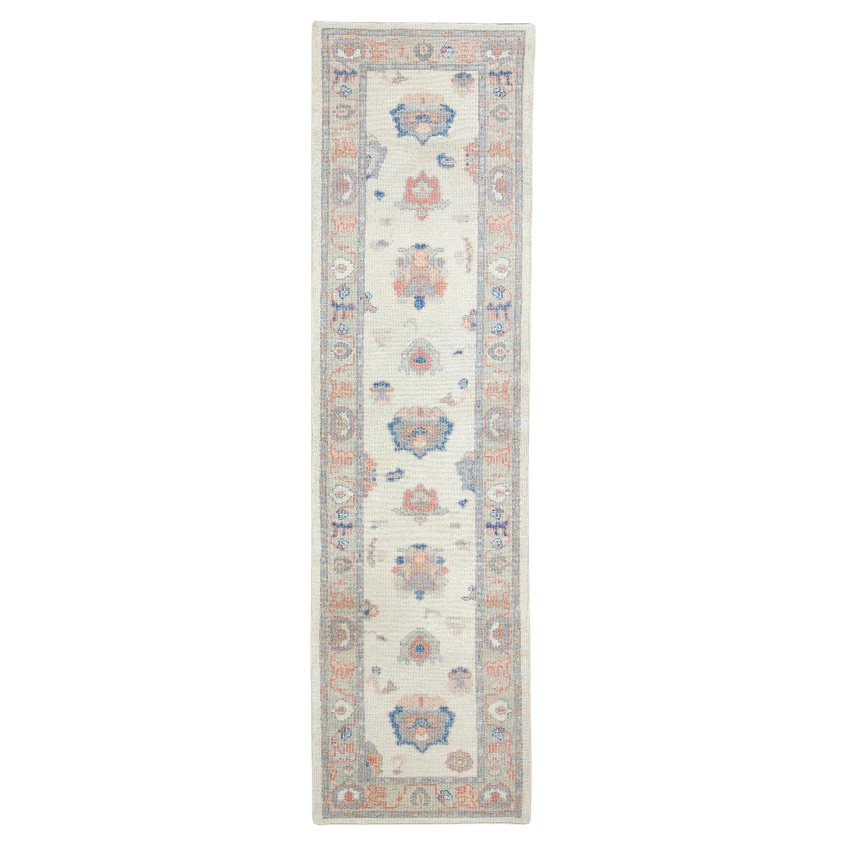Cream Handwoven Wool Turkish Oushak Rug in Blue & Pink Floral Design 2'9" x 9'9" For Sale