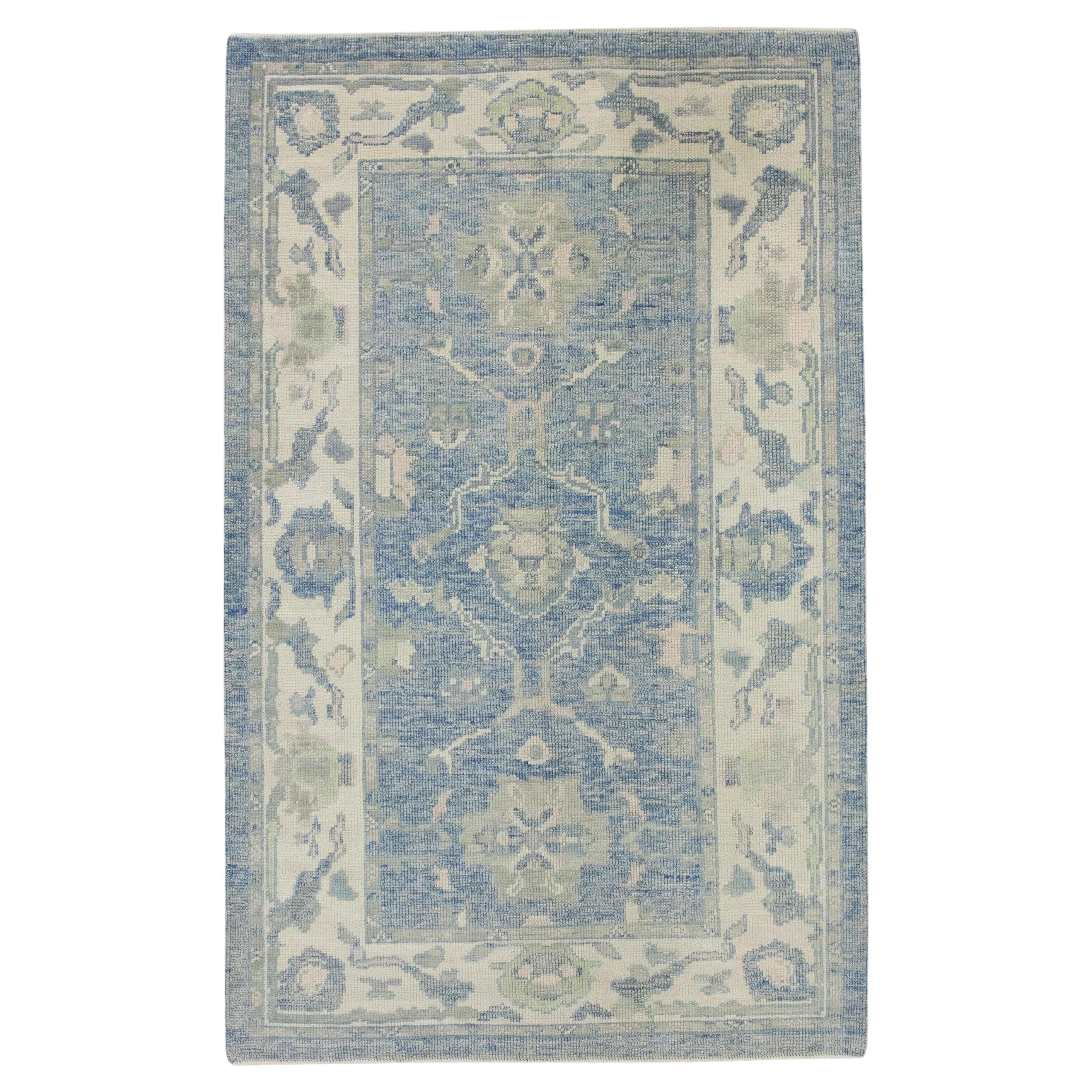 Blue Handwoven Wool Turkish Oushak Rug with Green Floral Pattern 4'1" x 6'5" For Sale