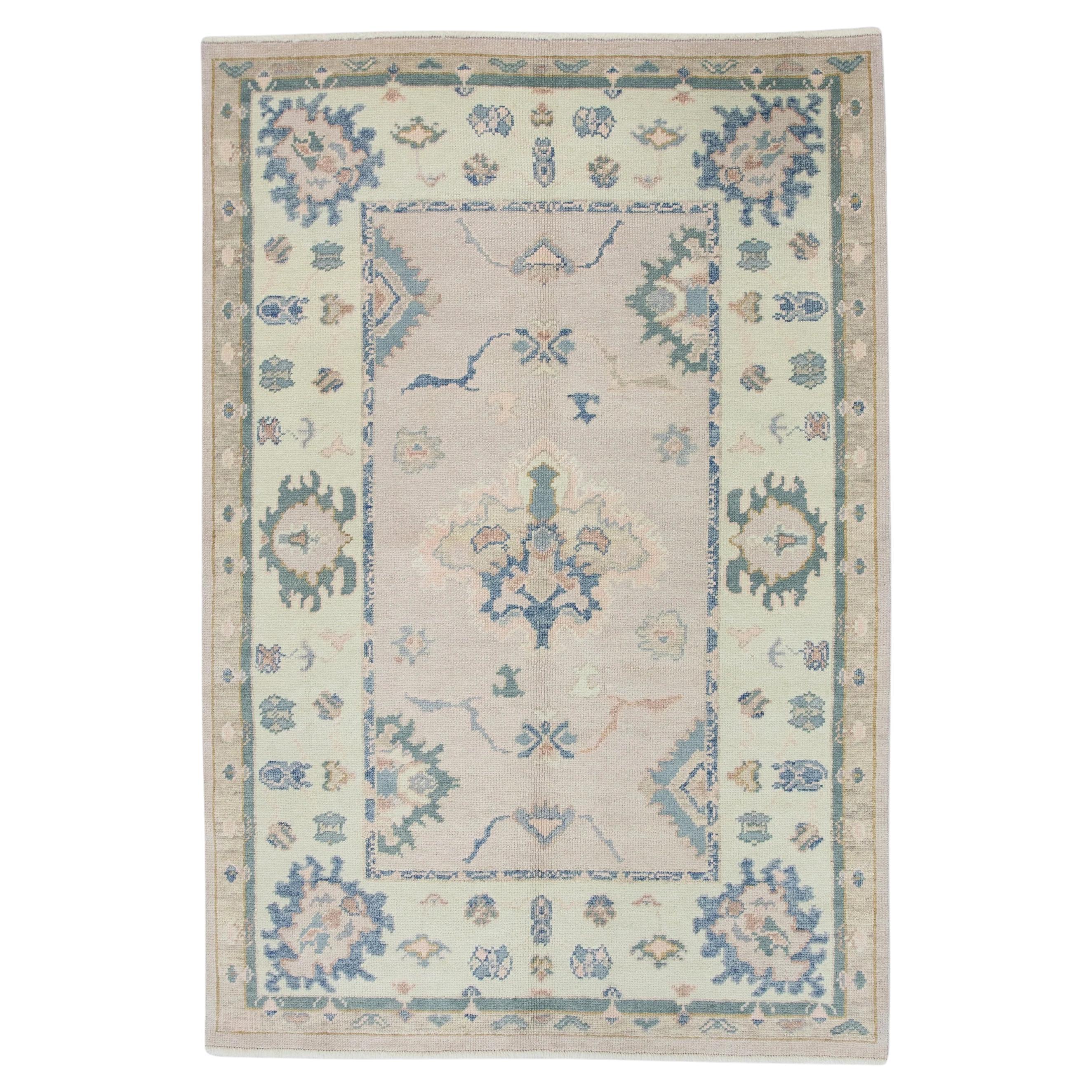 Soft Pink Handwoven Wool Turkish Oushak Rug in Blue Floral Pattern 4'11" x 7'
