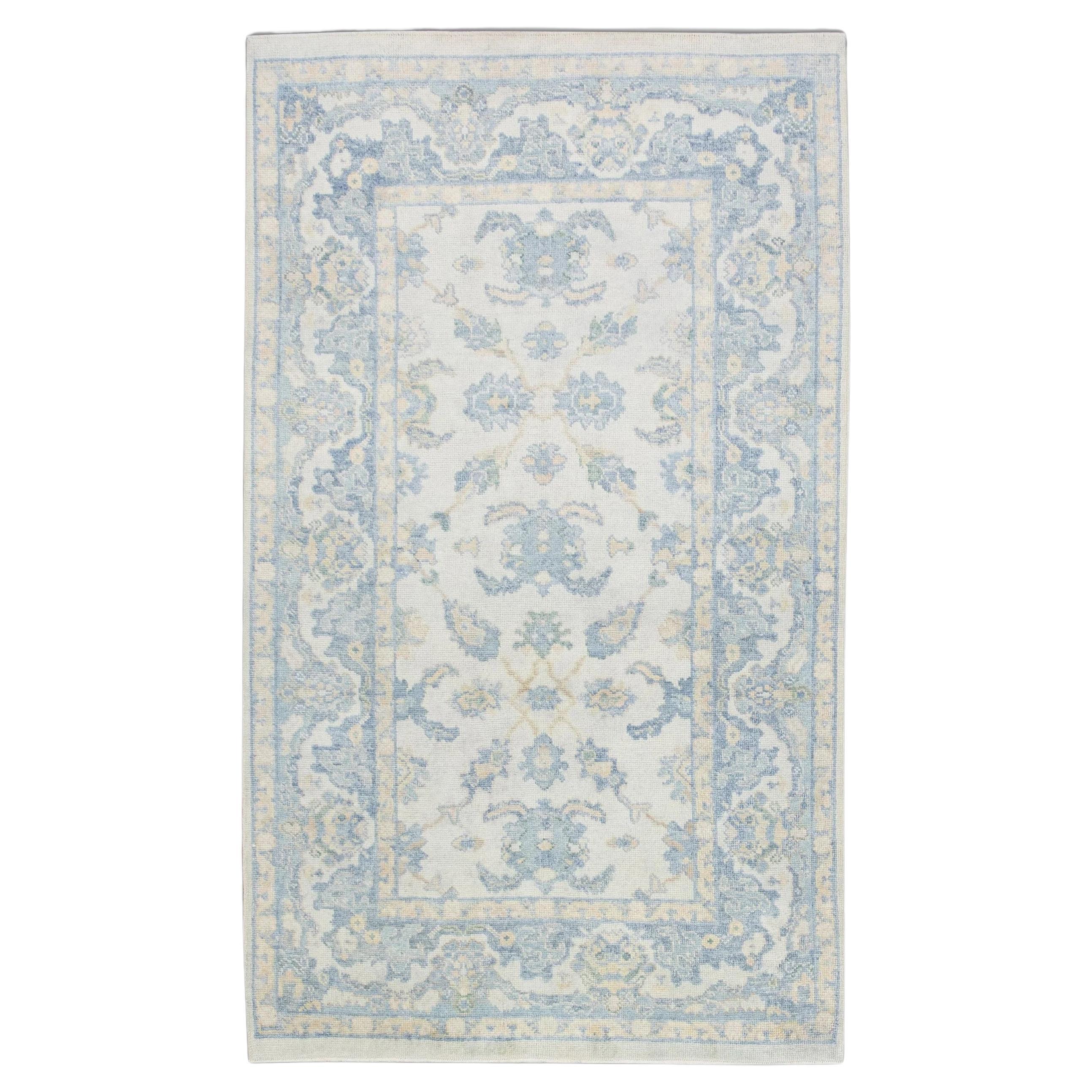 Soft Blue Handwoven Wool Turkish Oushak Rug with Floral Design 5' x 8'2" For Sale
