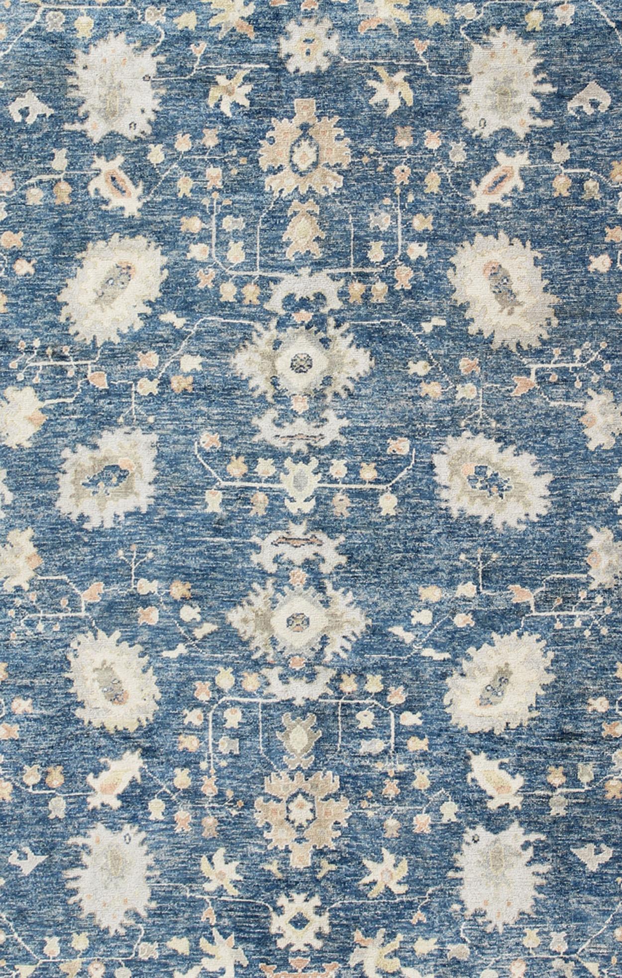 Hand-Knotted Turkish Oushak Rug in Blue Background, Neutral Colors and All-Over Design For Sale