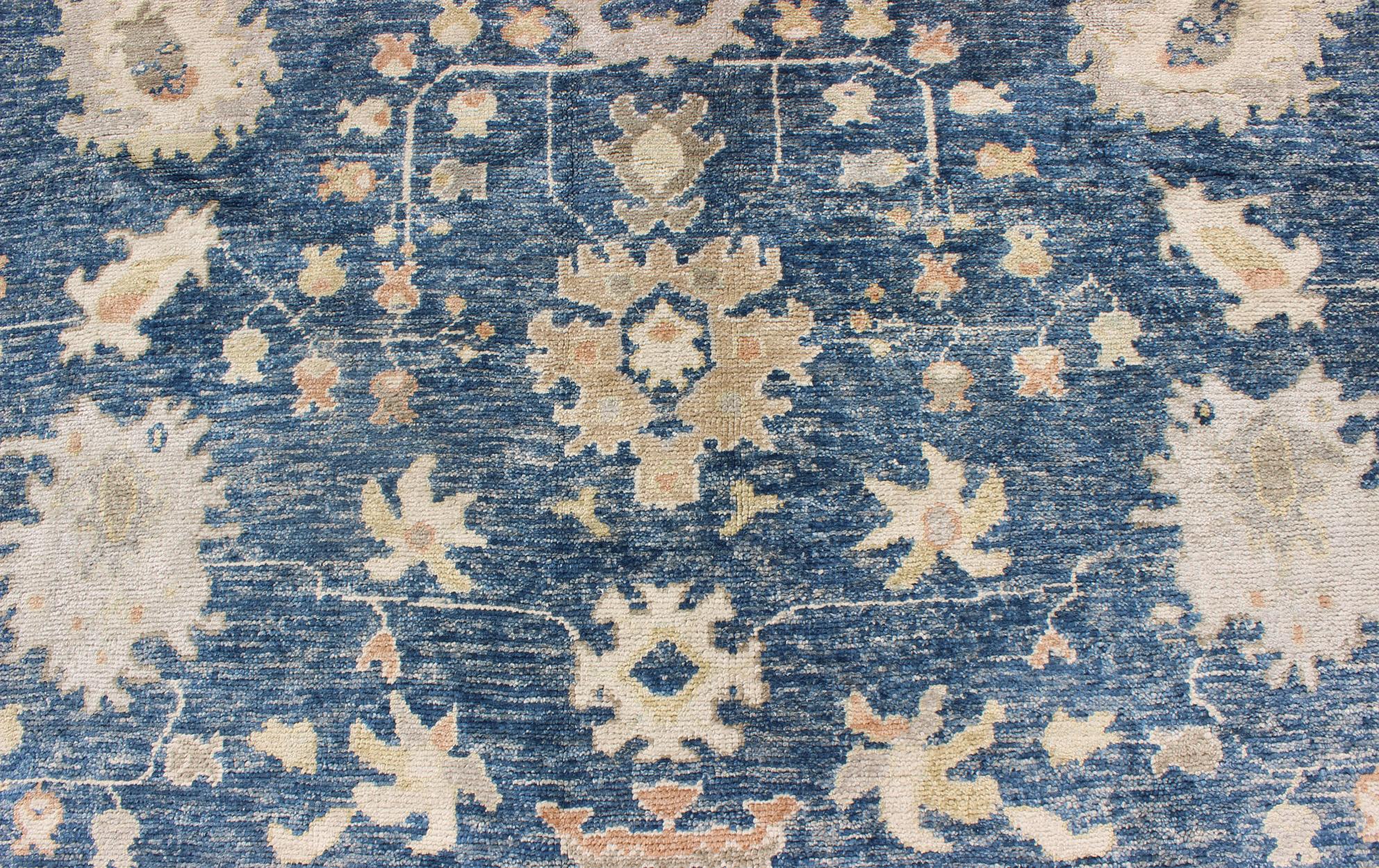 Wool Turkish Oushak Rug in Blue Background, Neutral Colors and All-Over Design For Sale