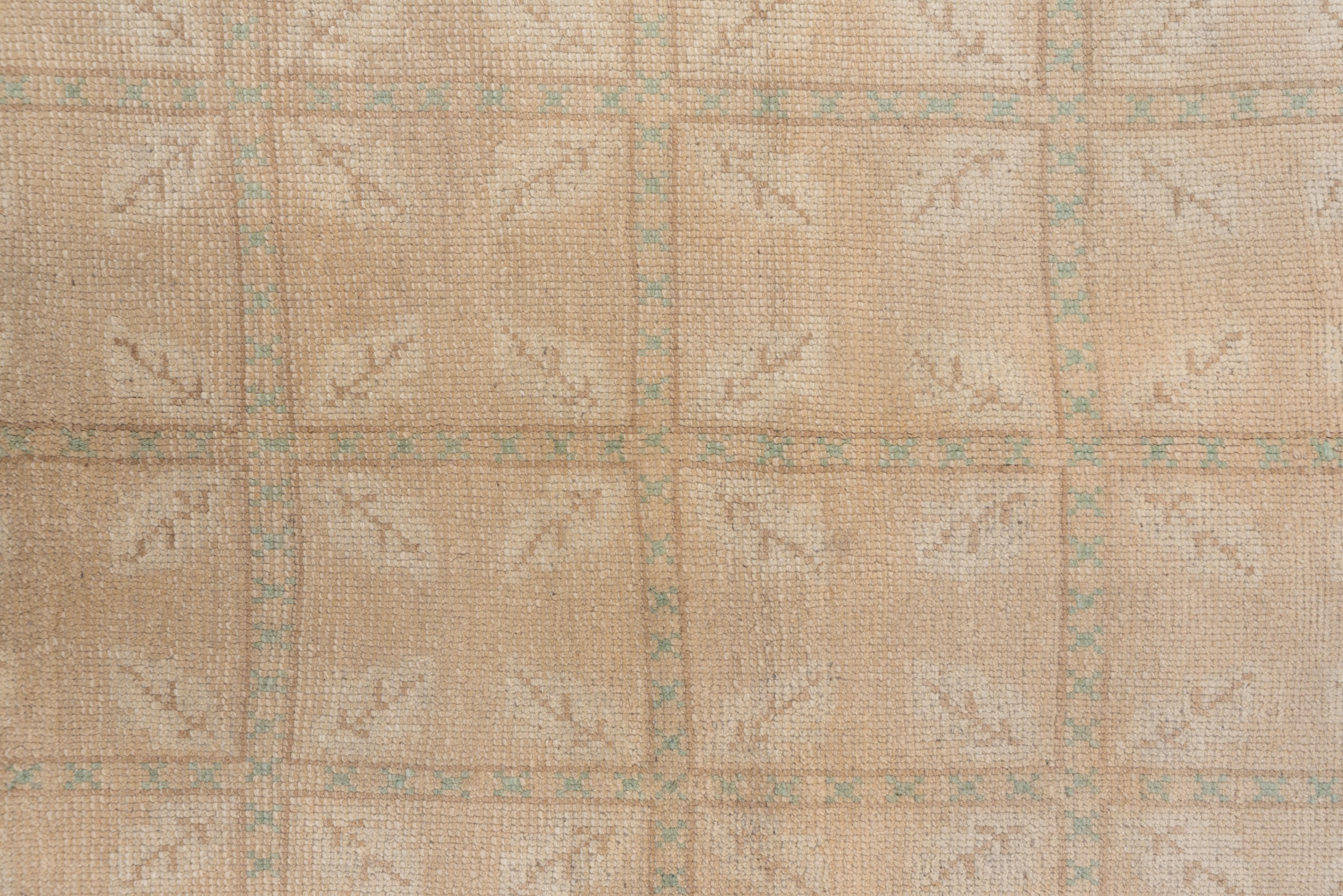 Four complete columns of sandy cream squares are decorated with four diagonal leaves each there is no border. Some details are in mottled red-brown, dark brown or light brown. The handle is especially floppy. The palette is soft and the style is Neo