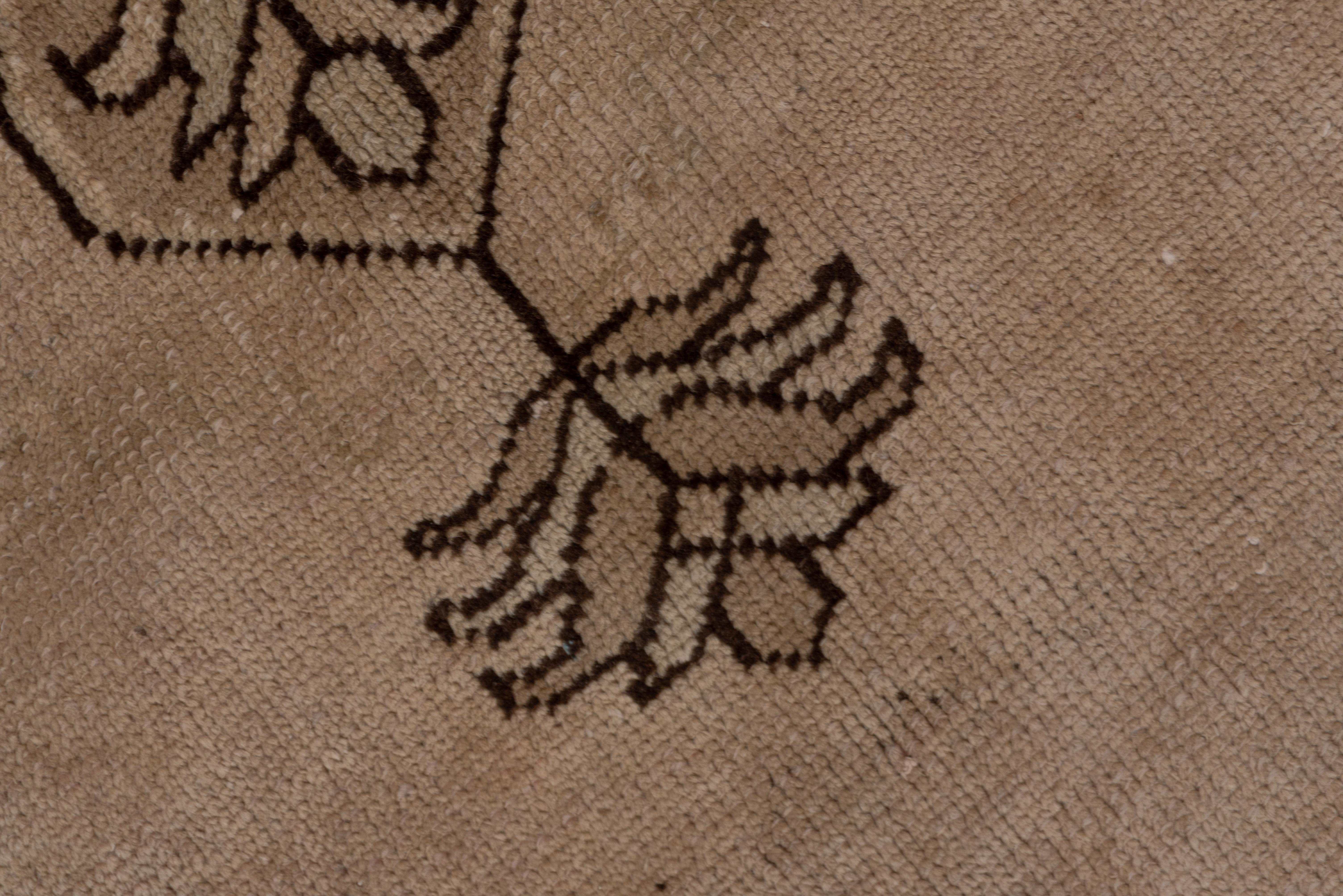 Dark brown accents the rosette and leaf soft brown border, and the beige field with a soft brown leaf palmette pendanted slightly lobed medallion. The pattern is mostly tone-on-tone.