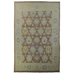 Turkish Oushak Rug with Blue and Gold Floral Details on Dark Brown Field